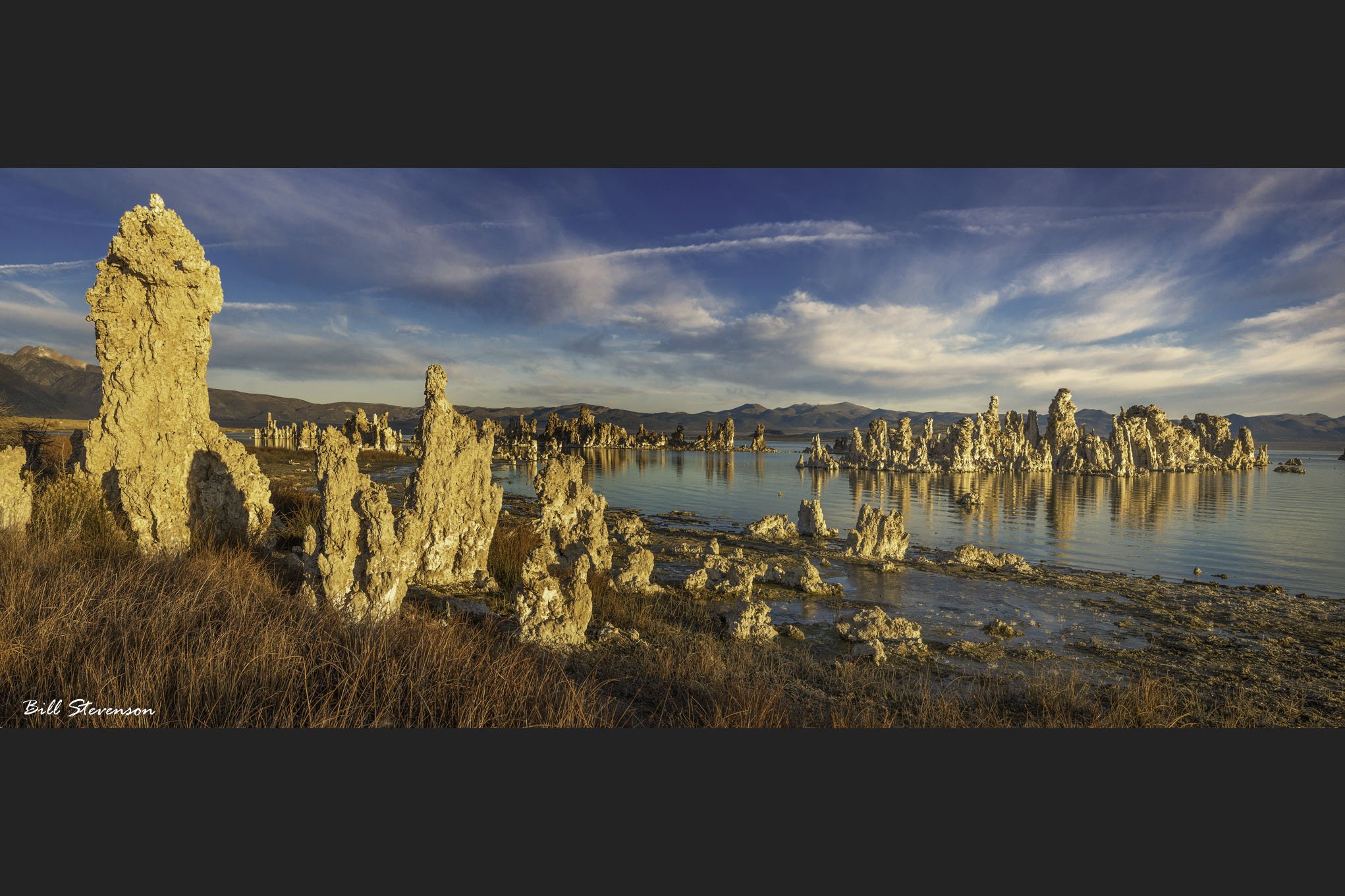 A fine art landscape panorama photo of tufa towers at Mono Lake.