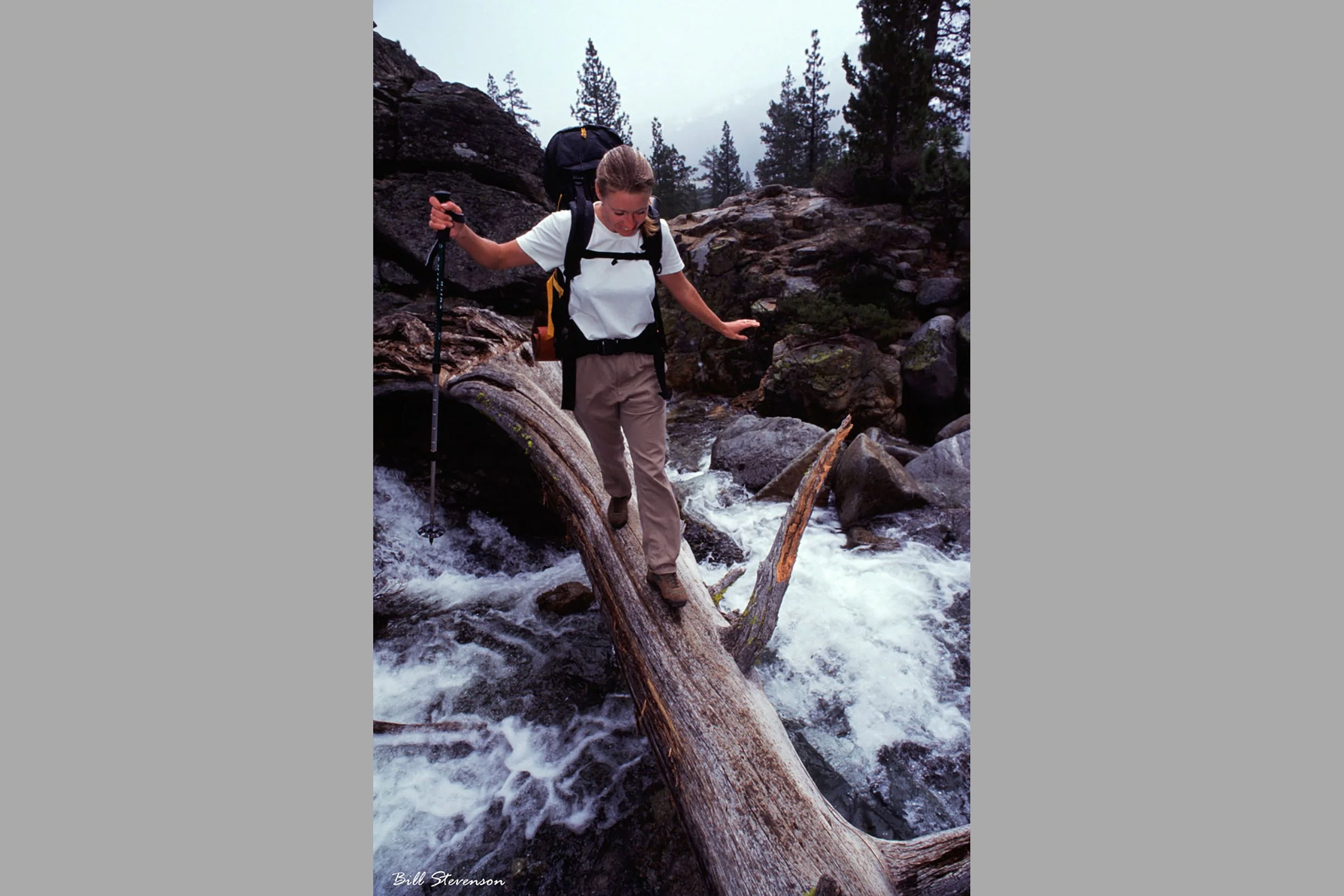 hiking across river log