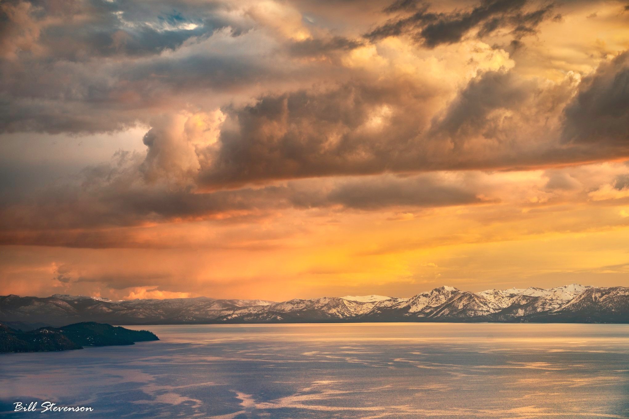 a SUMMER RAIN OVER LAKE TAHOE AT SUNSET