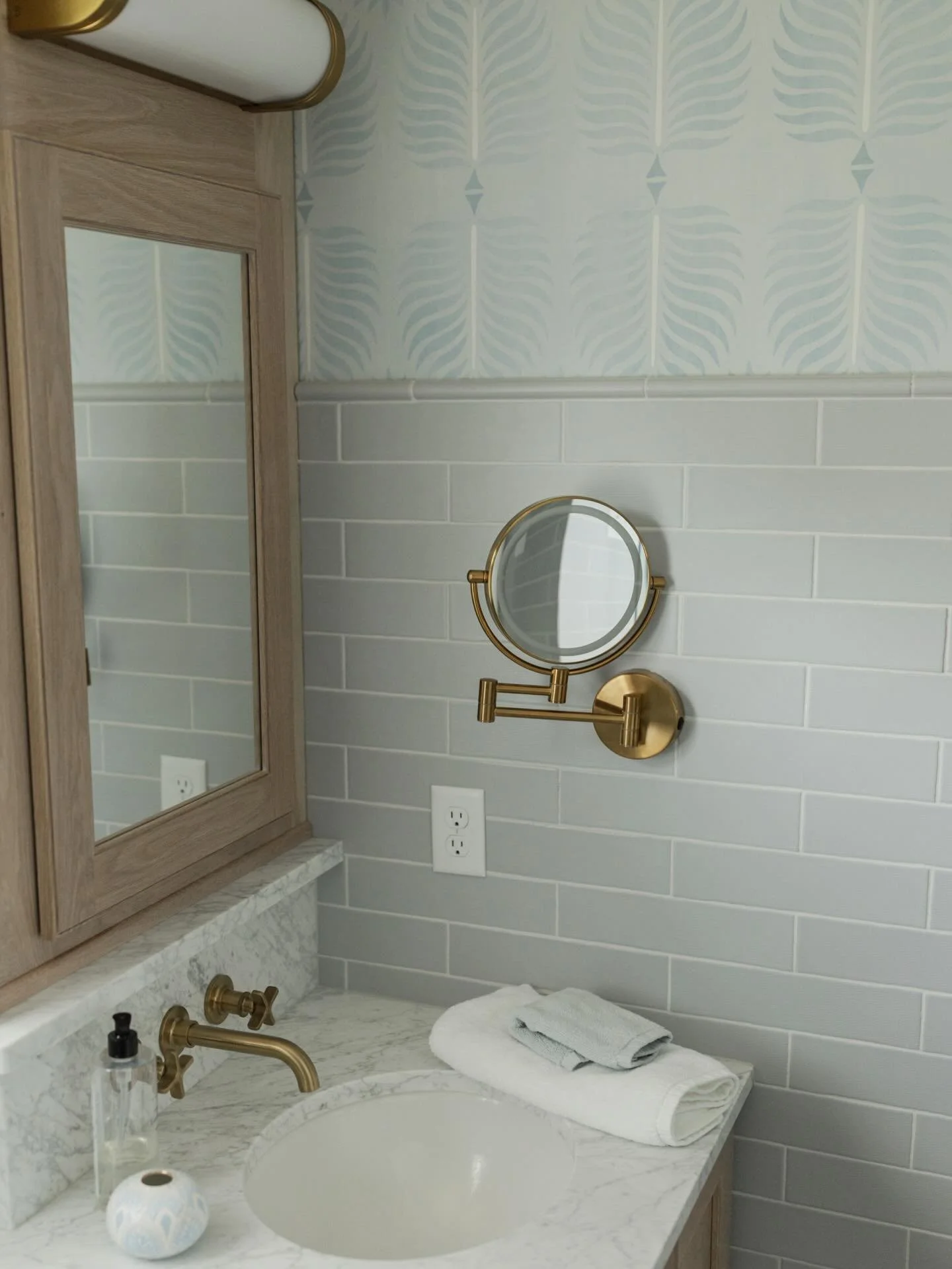 Wallpaper always says something.

This one whispers: you&rsquo;ve arrived somewhere special.

In this primary bath, every surface was considered, touched with intention, and layered to create more than beauty alone. The stone, the lighting, the textu