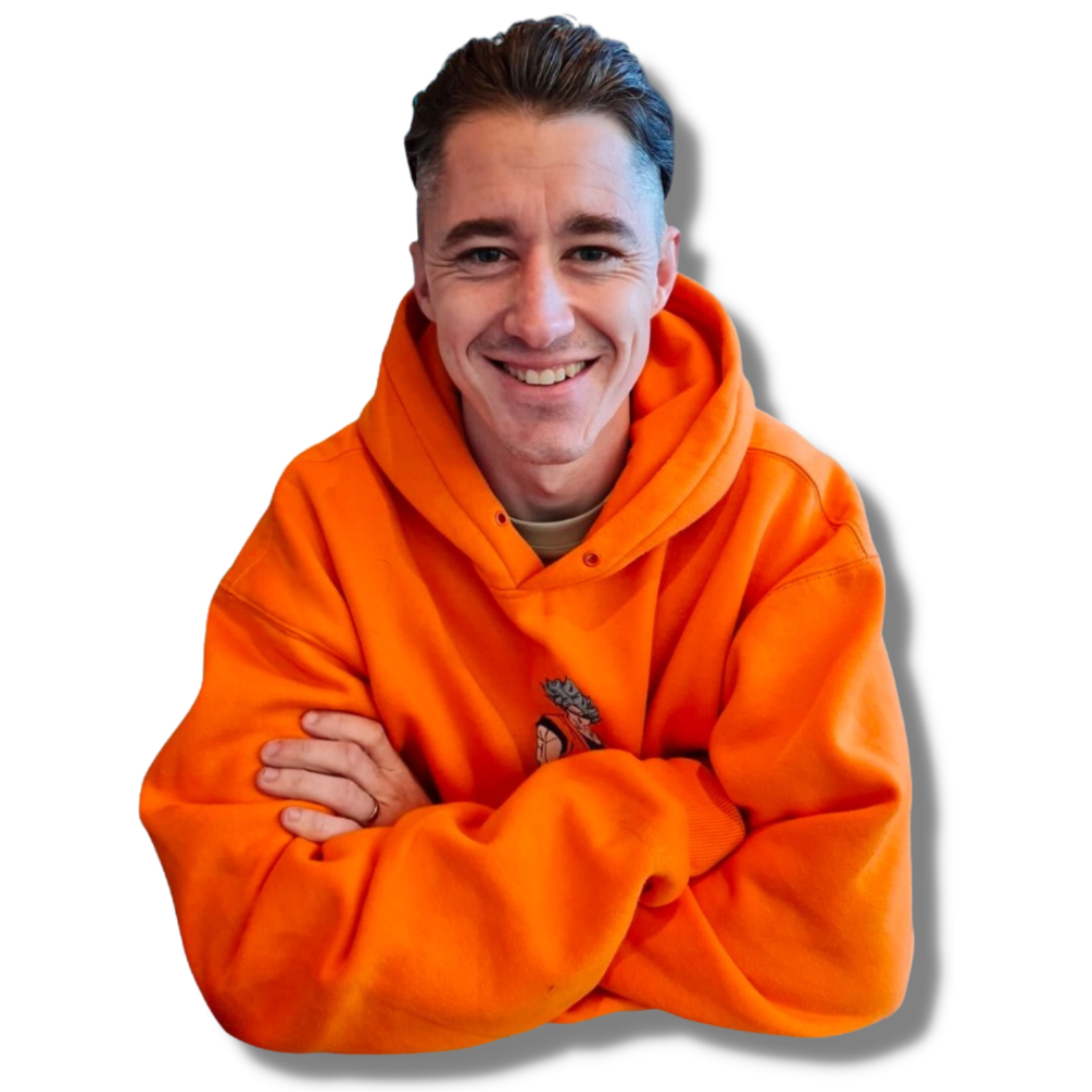 A young man smiling, wearing an orange hoodie, with crossed arms, against a black background.