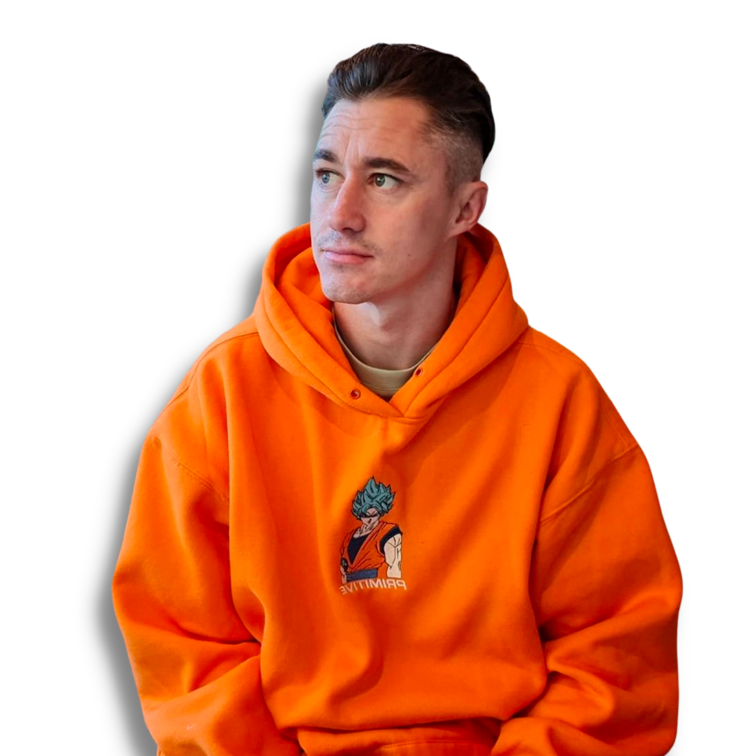 A young man with short brown hair wearing an orange hoodie with a Dragon Ball Z Goku graphic on it, sitting against a black background.
