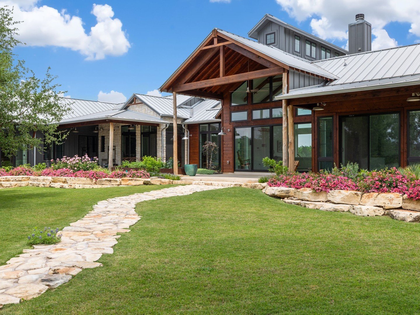 Spectacular custom home nestled in a pristine and private pocket of the Texas Hill Country. The home's interior features concrete flooring, wood beam accents, cathedral ceilings, and windows in nearly every room. The main living room showcases a near