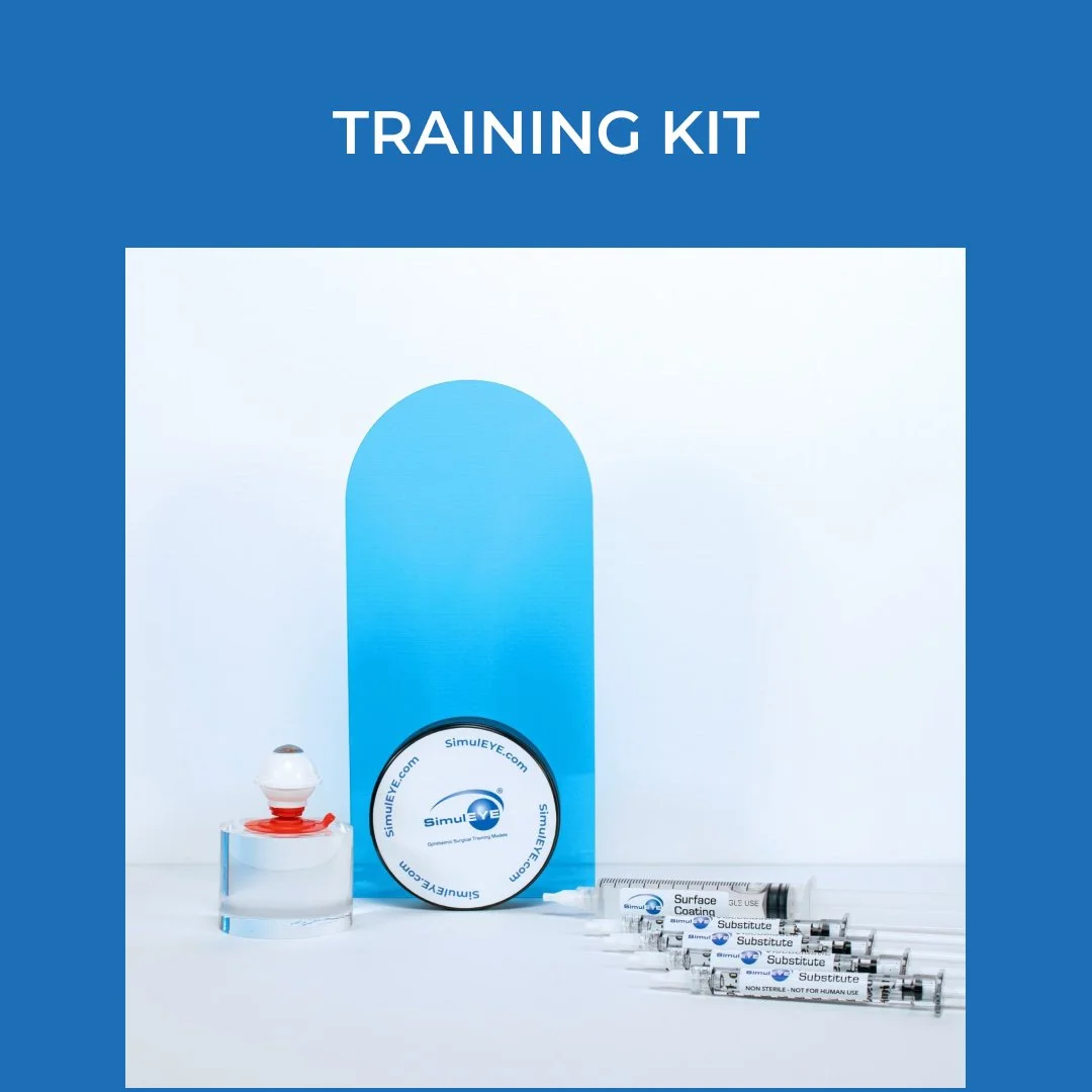 A training kit with a blue box labeled 'Training Kit,' a circular container with 'SimulEYE' written on it, a red and white eye model, and five syringes labeled 'Substitute' and 'Surface Coating' arranged on a white surface.