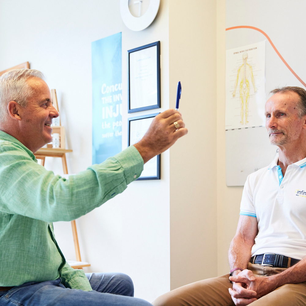 Dr Gary Dennis talking with a client