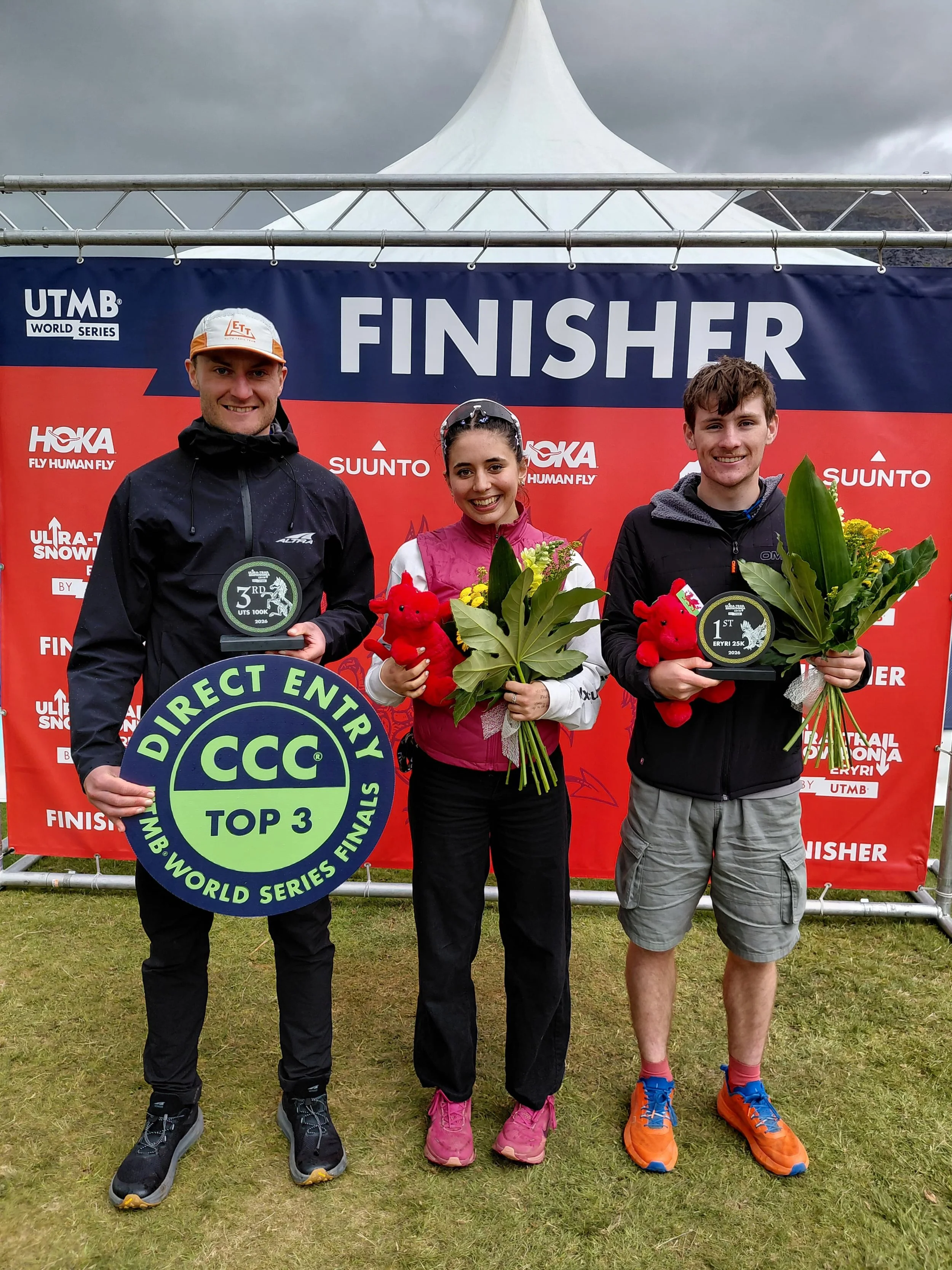 Three runners with their trophies at the podium of Ultra-Trail Snowdonia