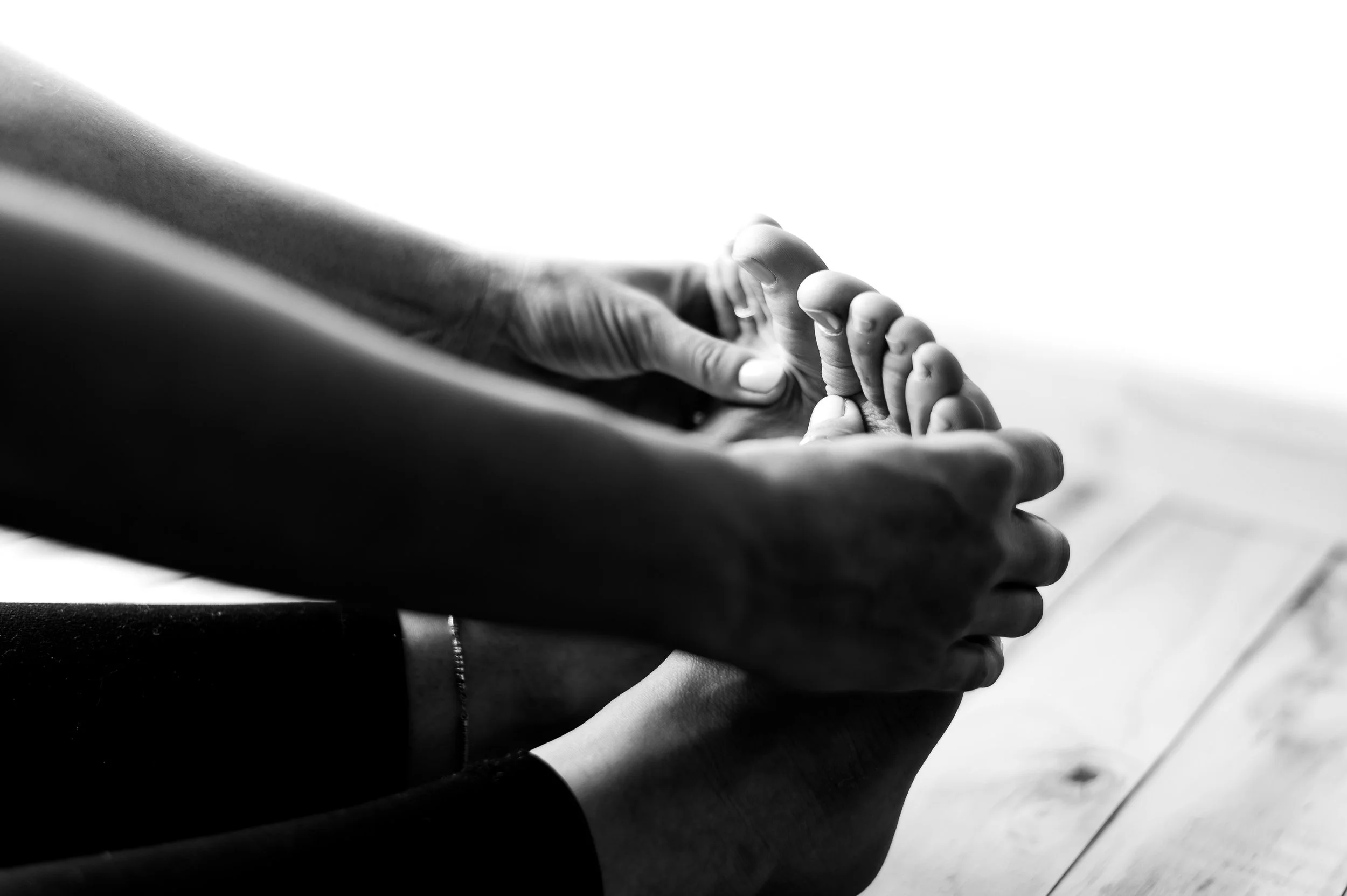 During a wellness and preventative care session with Jermaine Lindsey with 4Life Chiropractic & Wellness, a client stretches to reach their toes.