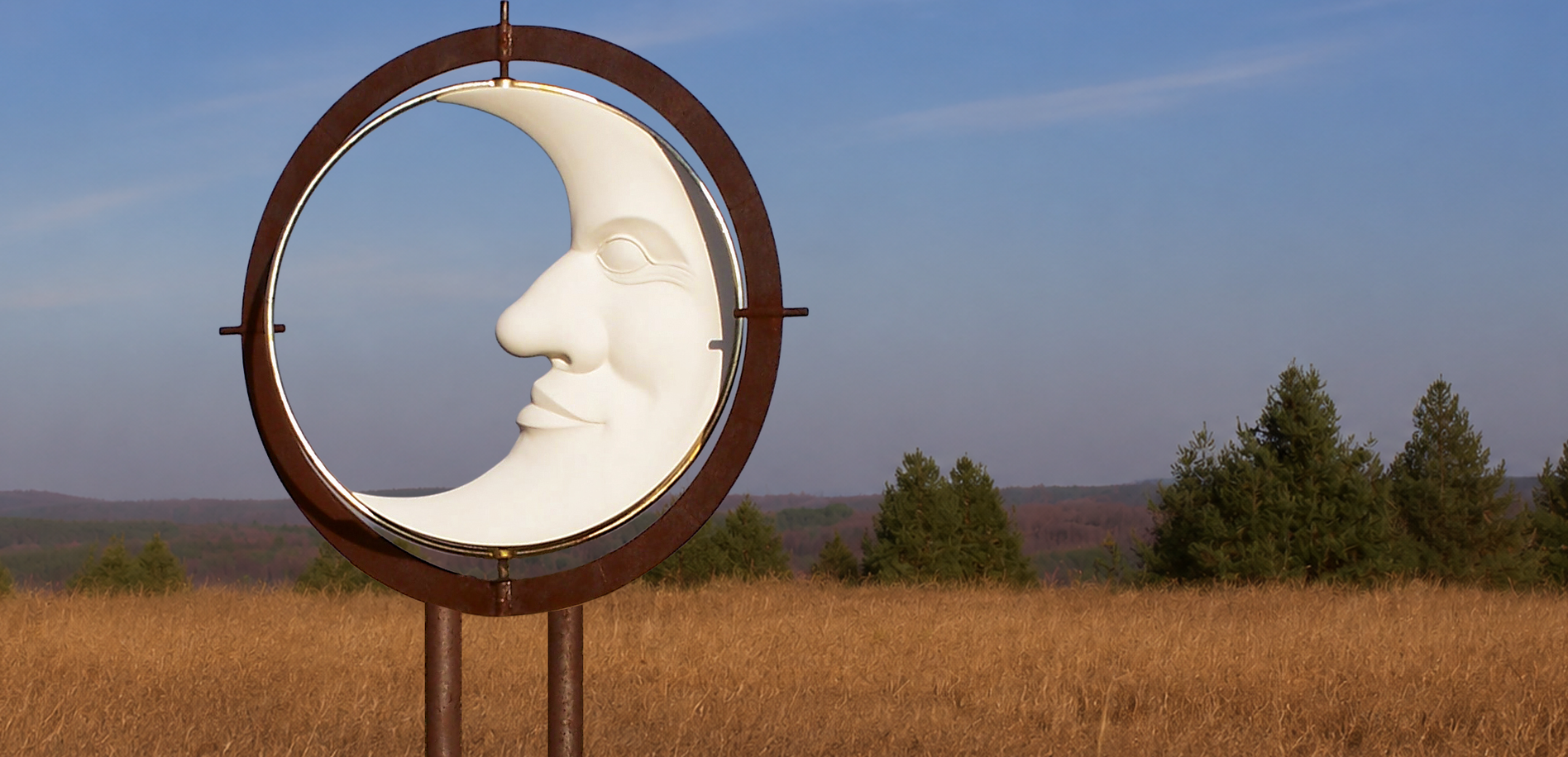 Kinetic moon sculpture rotating above the Saugeen River valley in Ontario.