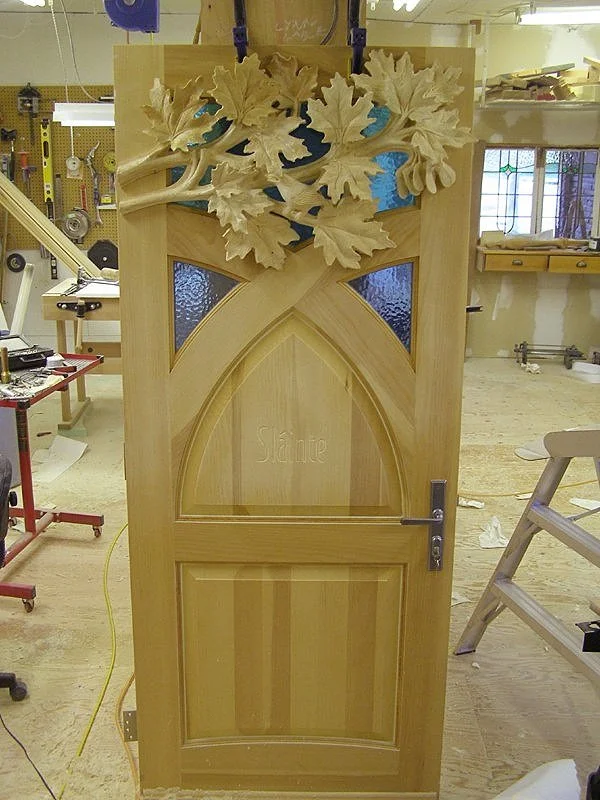A hand-carved painted pine entrance inspired by Southern Georgian Bay, heritage orchards, and the changing qualities of light.