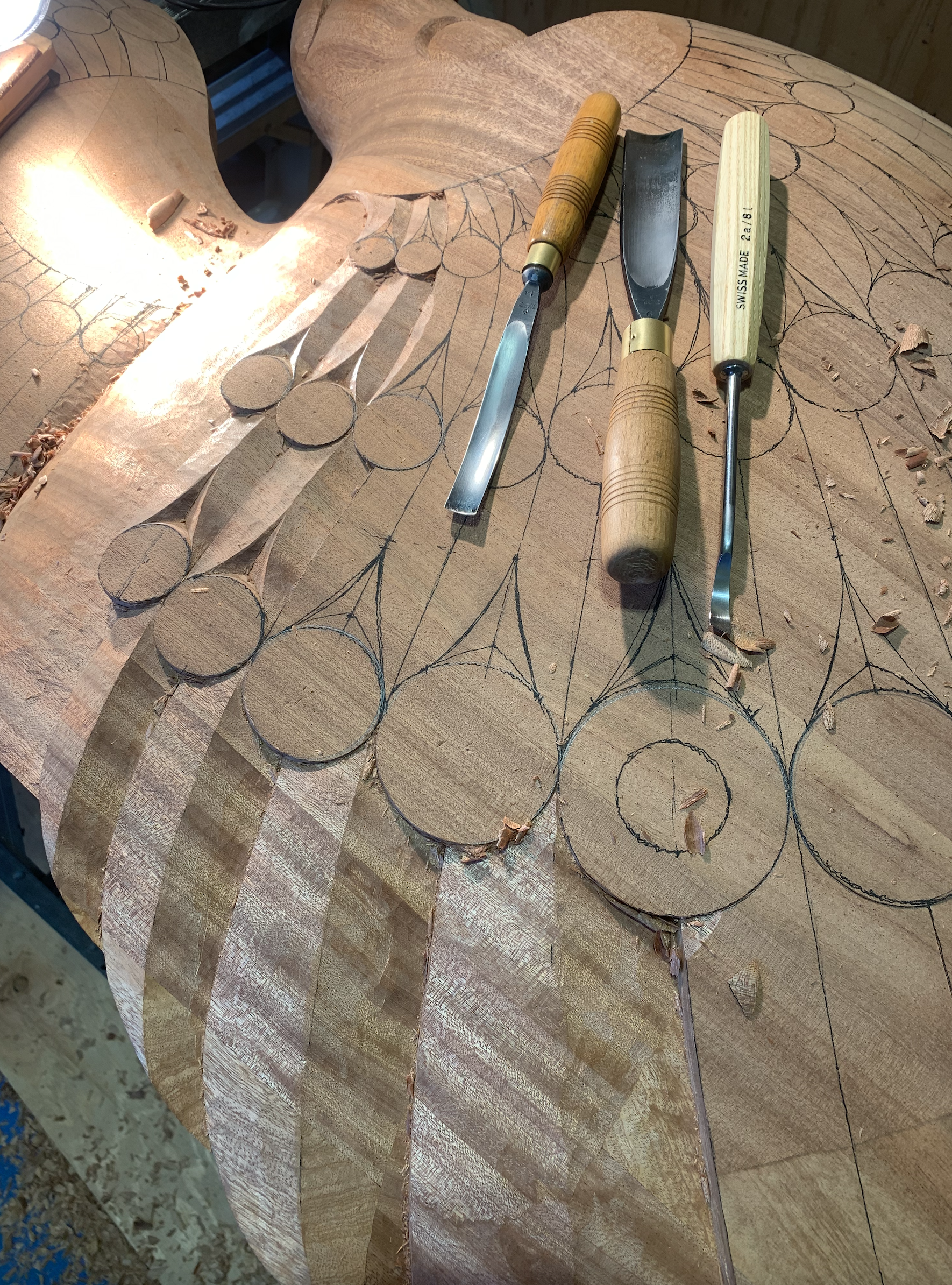 Carved raven detail in a mahogany entrance door with stained glass elements.