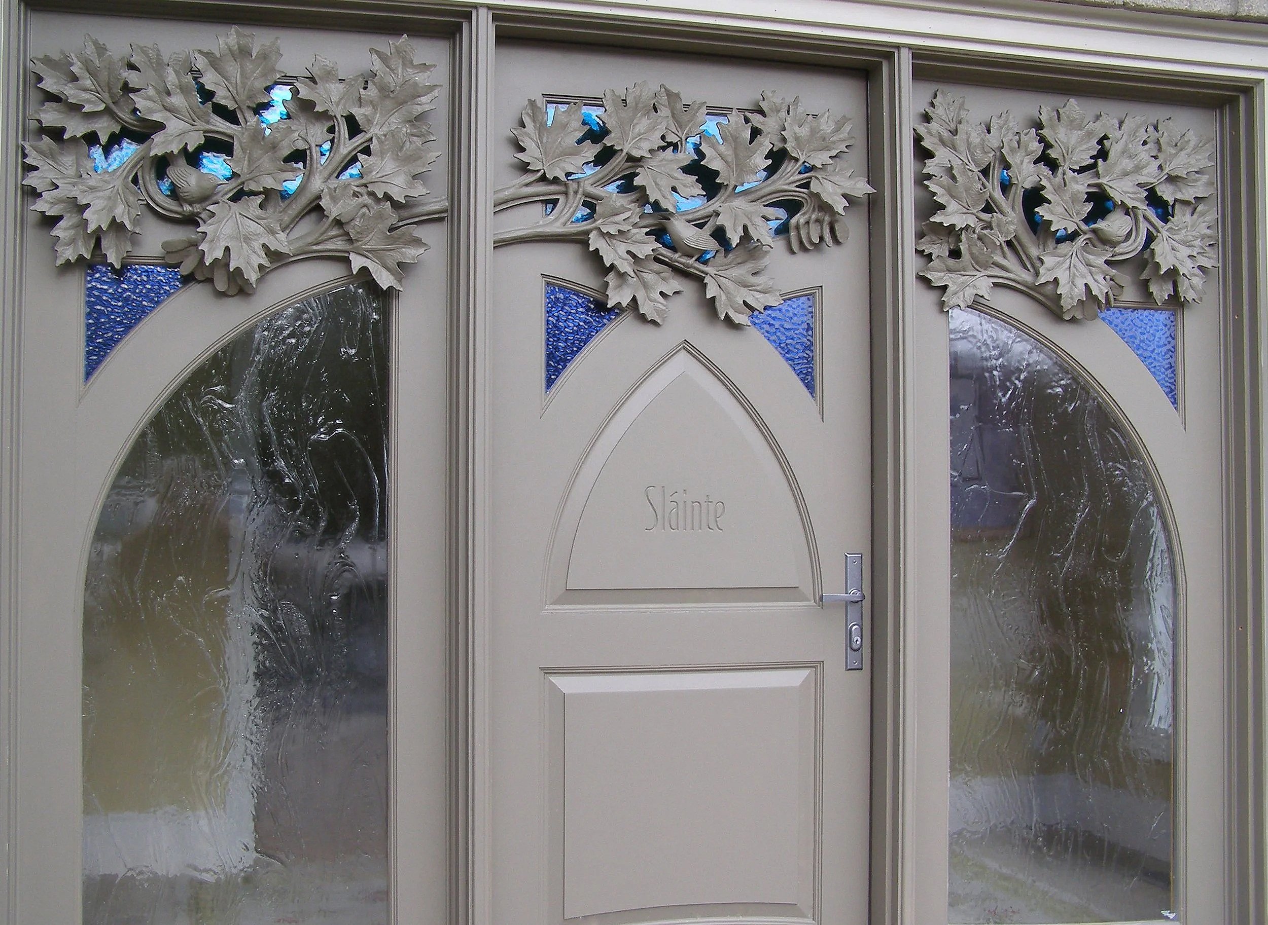 A hand-carved painted pine entrance inspired by Southern Georgian Bay, heritage orchards, and the changing qualities of light.