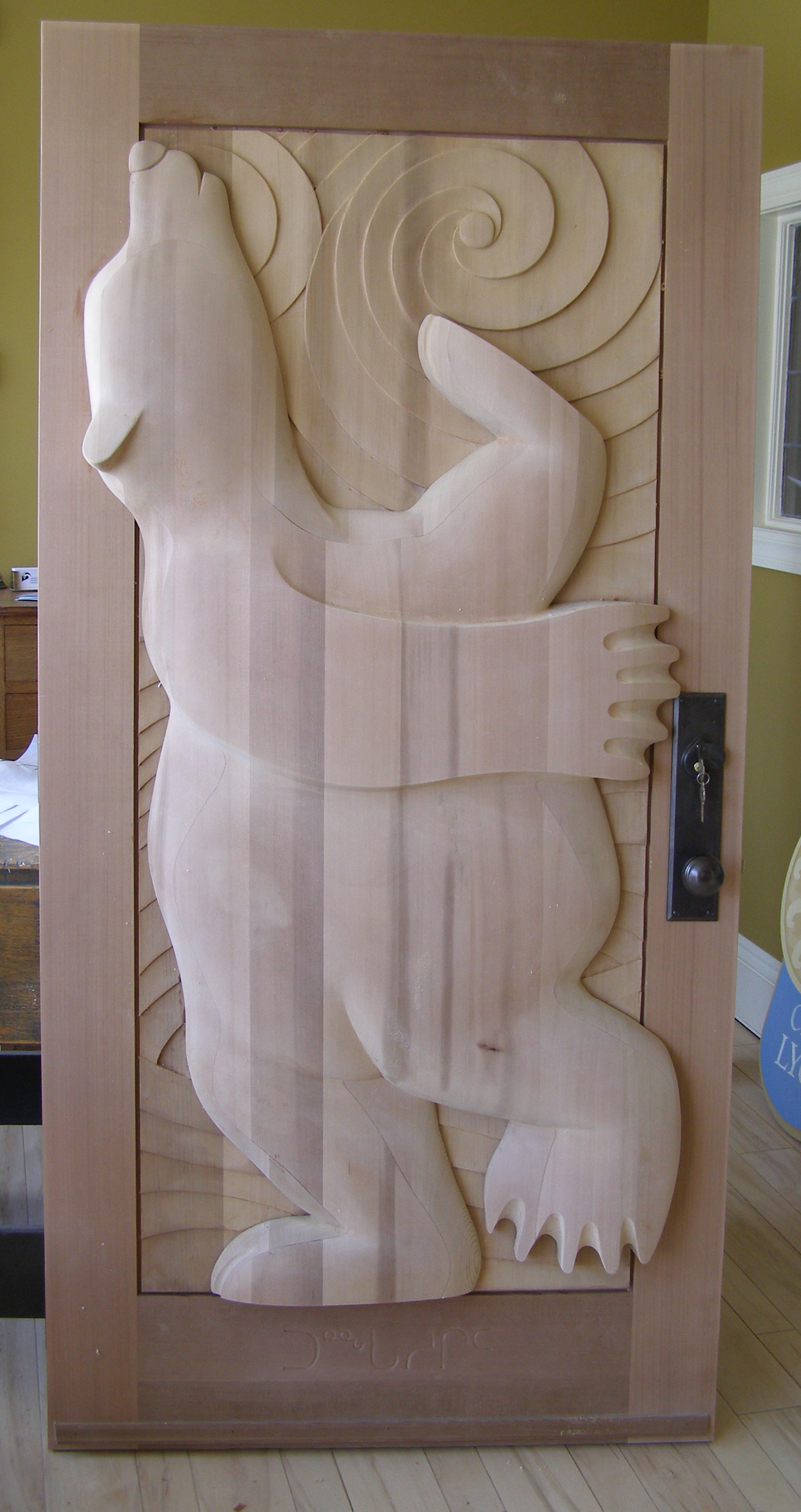 Wooden door with a carved design of a dancing bear against the swirling winds anganst the glow of the Polaris, in a sleek, minimalist style.