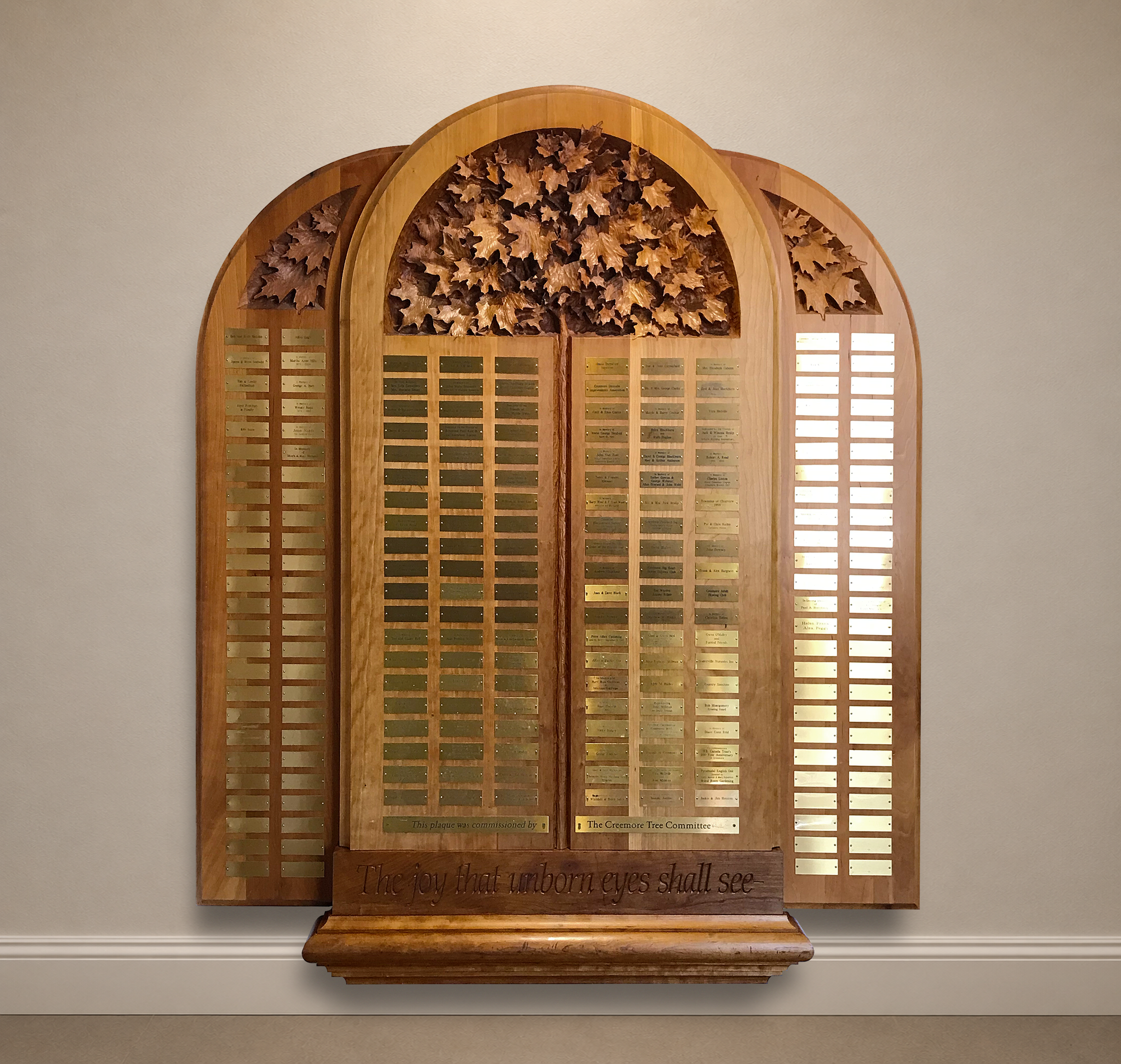 Hand-carved memorial tree sculpture with donor recognition elements.