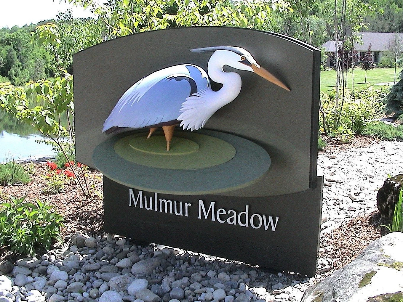 Sculptural place marker for Mulmur Meadow featuring a heron and native landscape motifs.