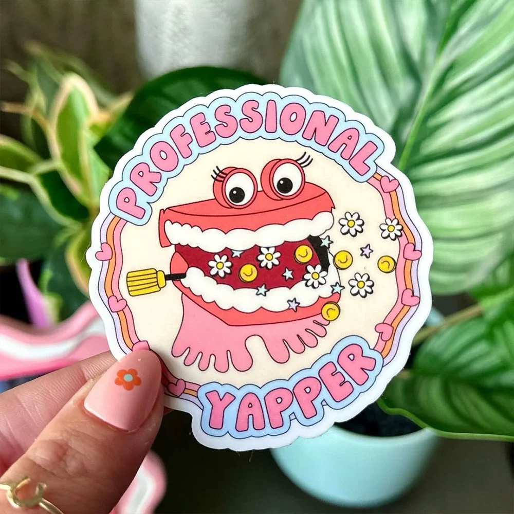 Sticker with a cartoon character of a ladybug with big eyes, holding a broom, surrounded by flowers and stars, with the words "Professional Yapper" in colorful letters.