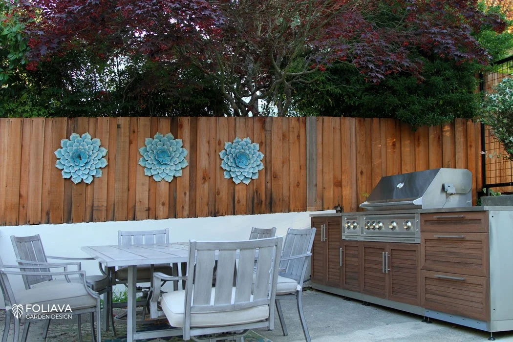 Luxury backyard dining area with contemporary hardscape and sleek outdoor kitchen.