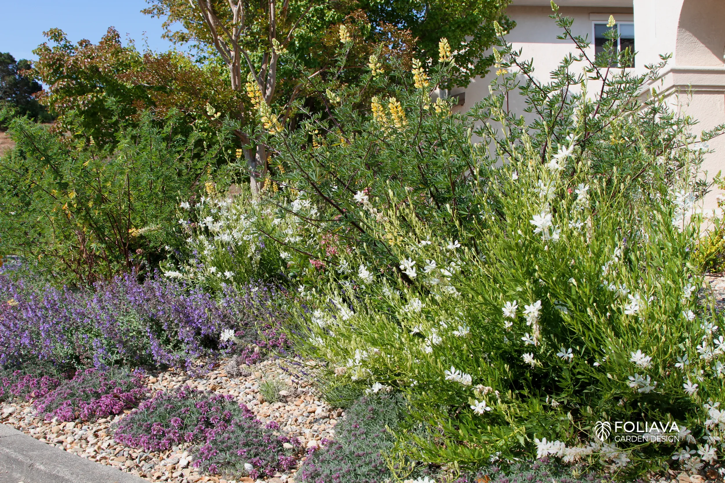 Corner home’s curb appeal elevated with a pastel flower landscape.
