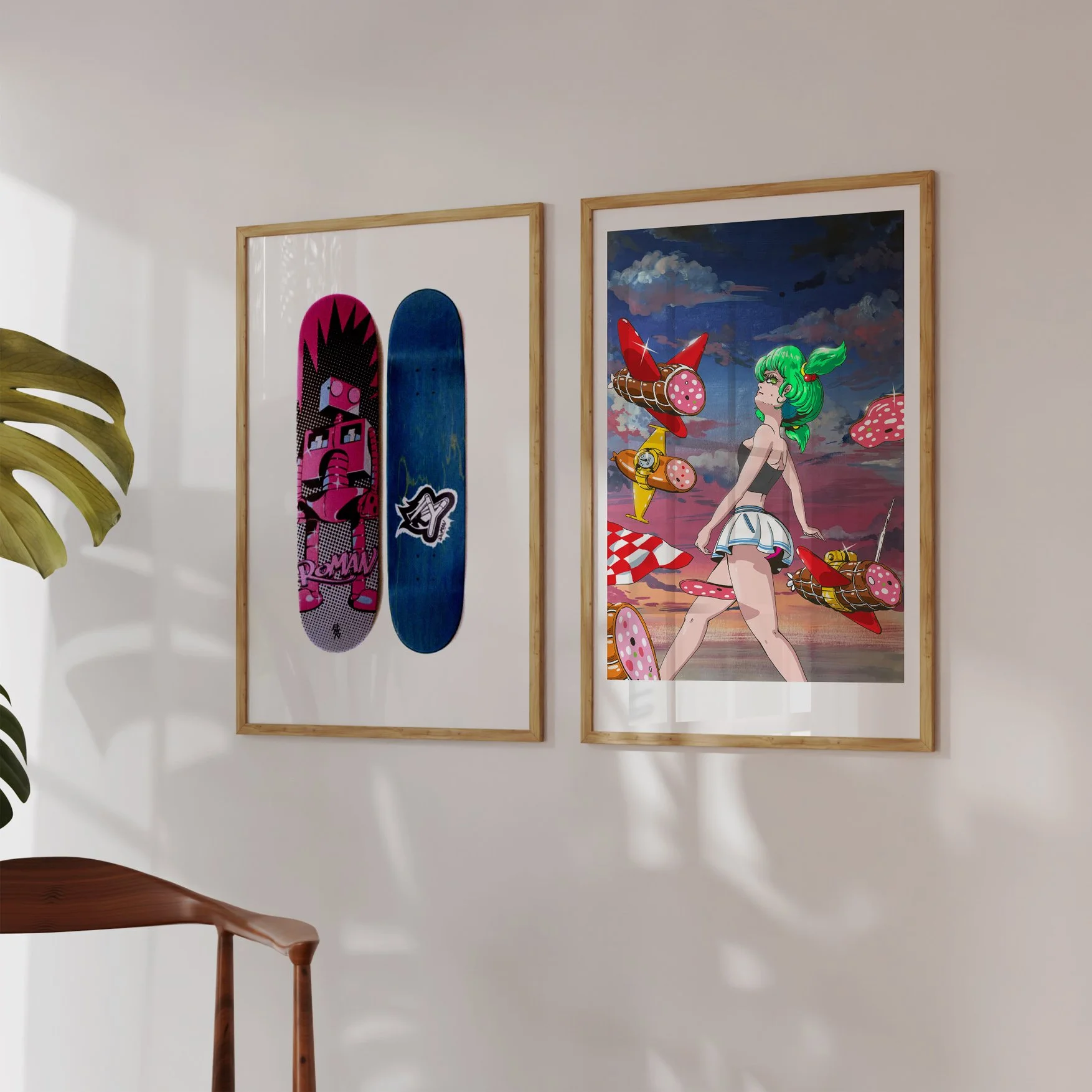Two framed prints by ARMNP of skateboards and a whimsical flying salami print are shown against a white wall backdrop.