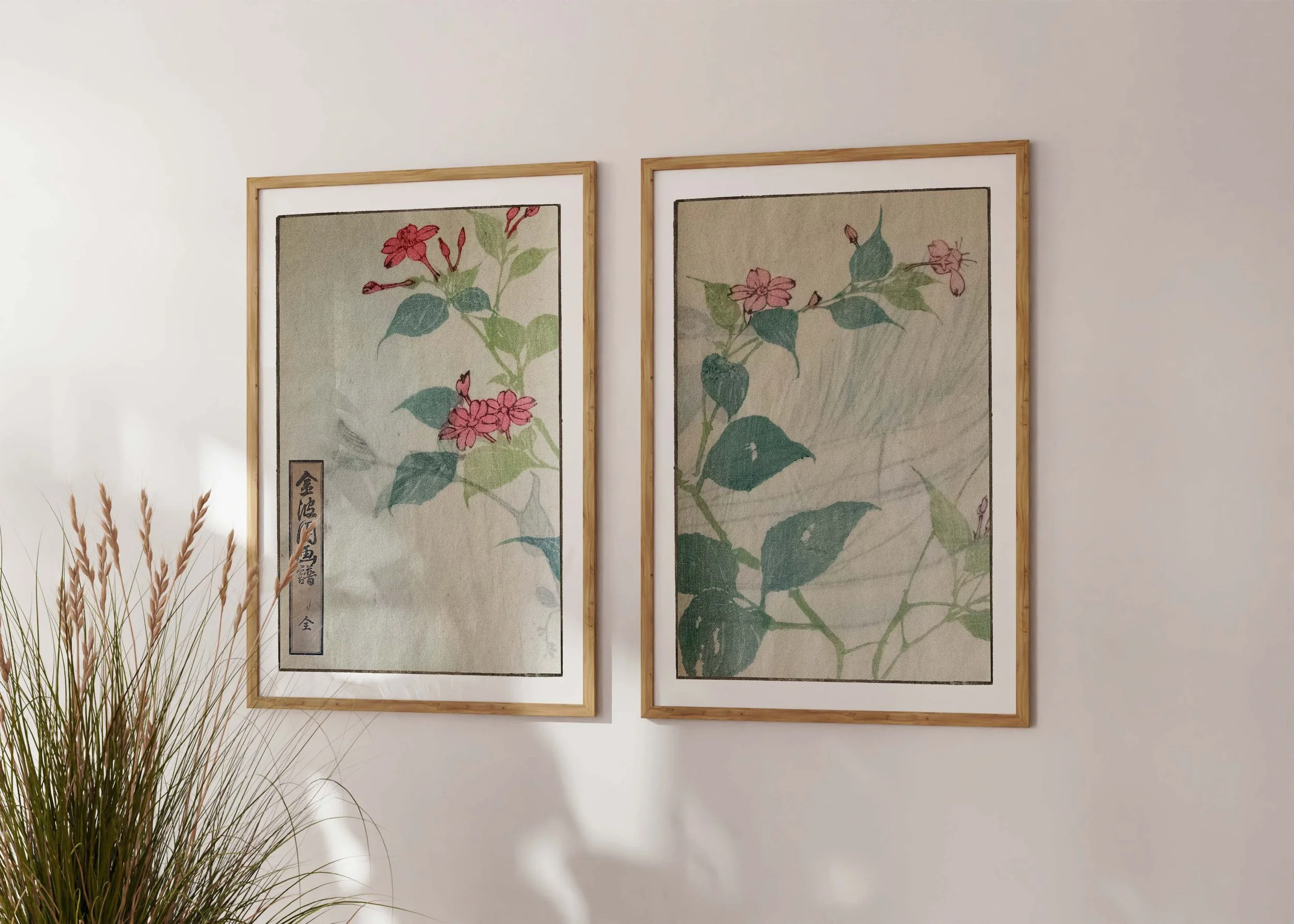 Framed set of two prints of Bunpo Kawamura’s Pinkuuniuni set with pink weigela-like flowers on a sunlit wall.