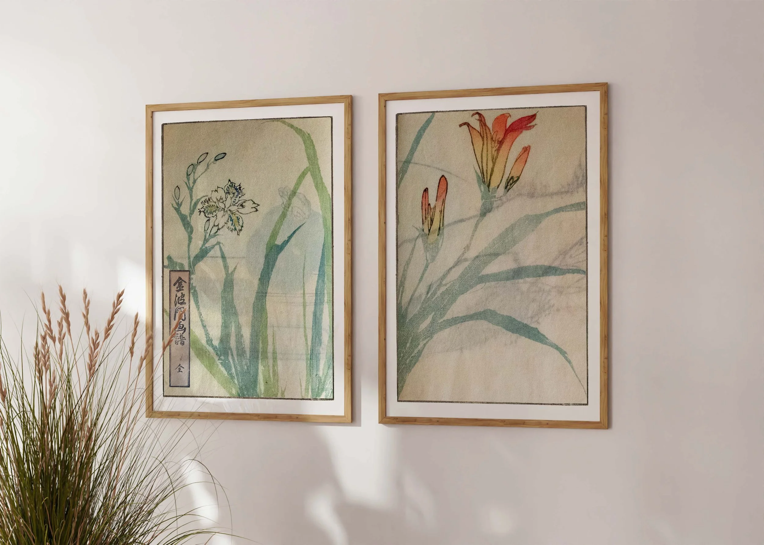 Framed set of two prints of Bunpo Kawamura’s Deiri set with daylilies on a sunlit wall.