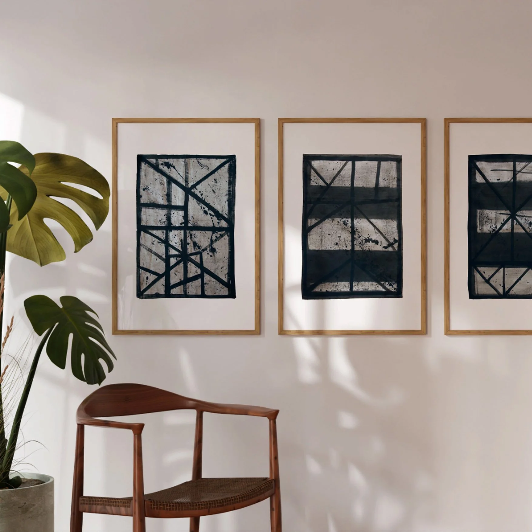 Set of three framed abstract line art prints (Flint 6, Flint 8, Flint10) leaning against a sunlit wall.