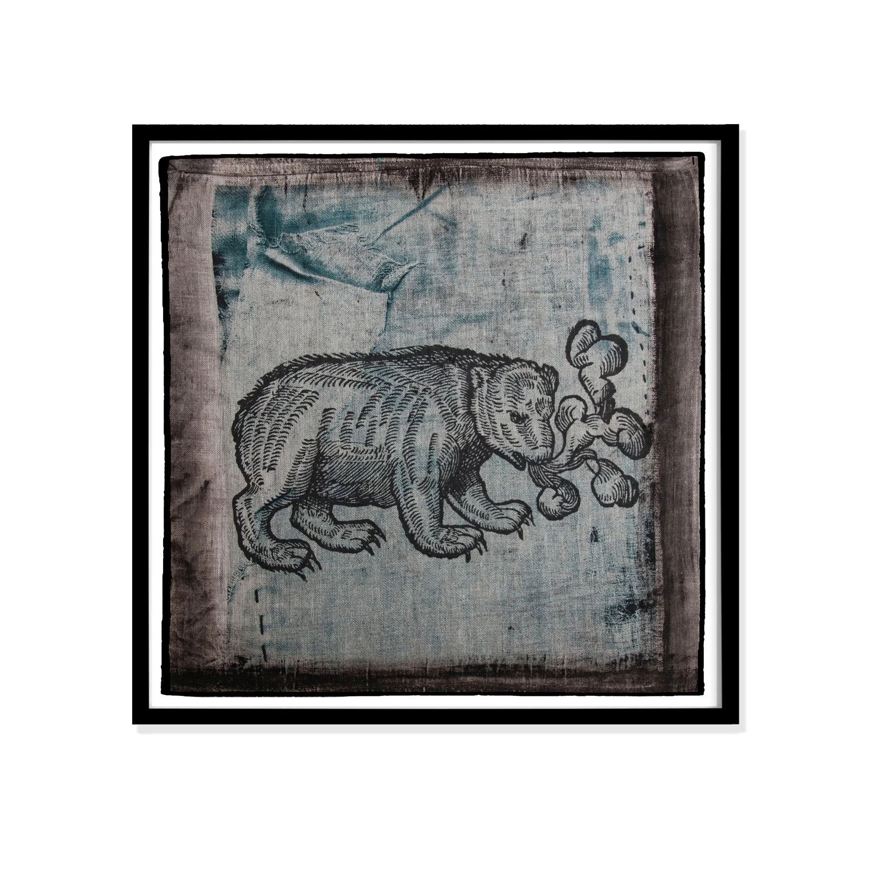 Bear illustration by Claude Paradin with antique linen in a black frame against a white wall.