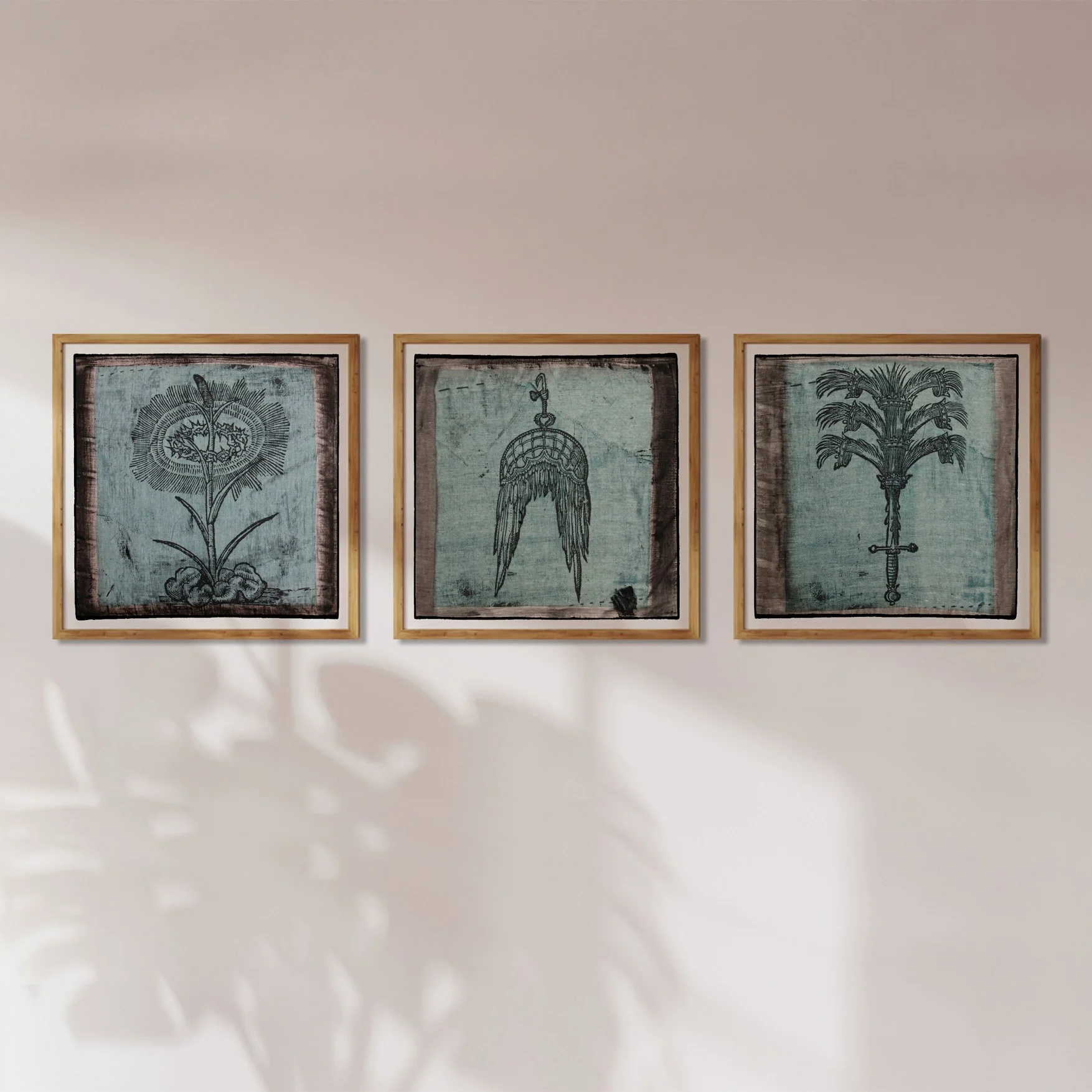Three framed prints of illustrations by Claude Paradin onto antique linen (spring, shade, crown).