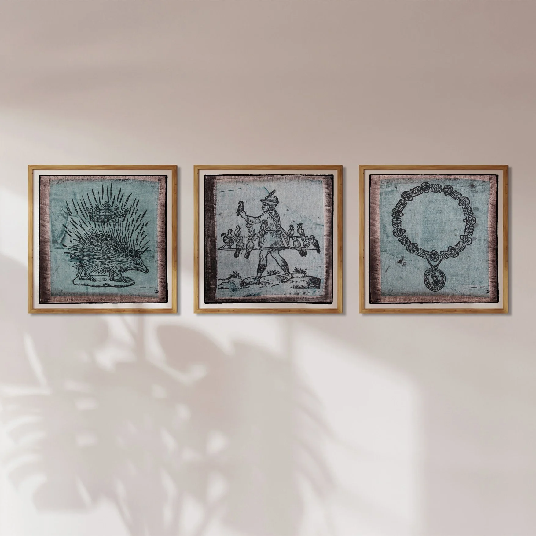 Three framed prints of illustrations by Claude Paradin onto antique linen (Spike, birds, pendant).
