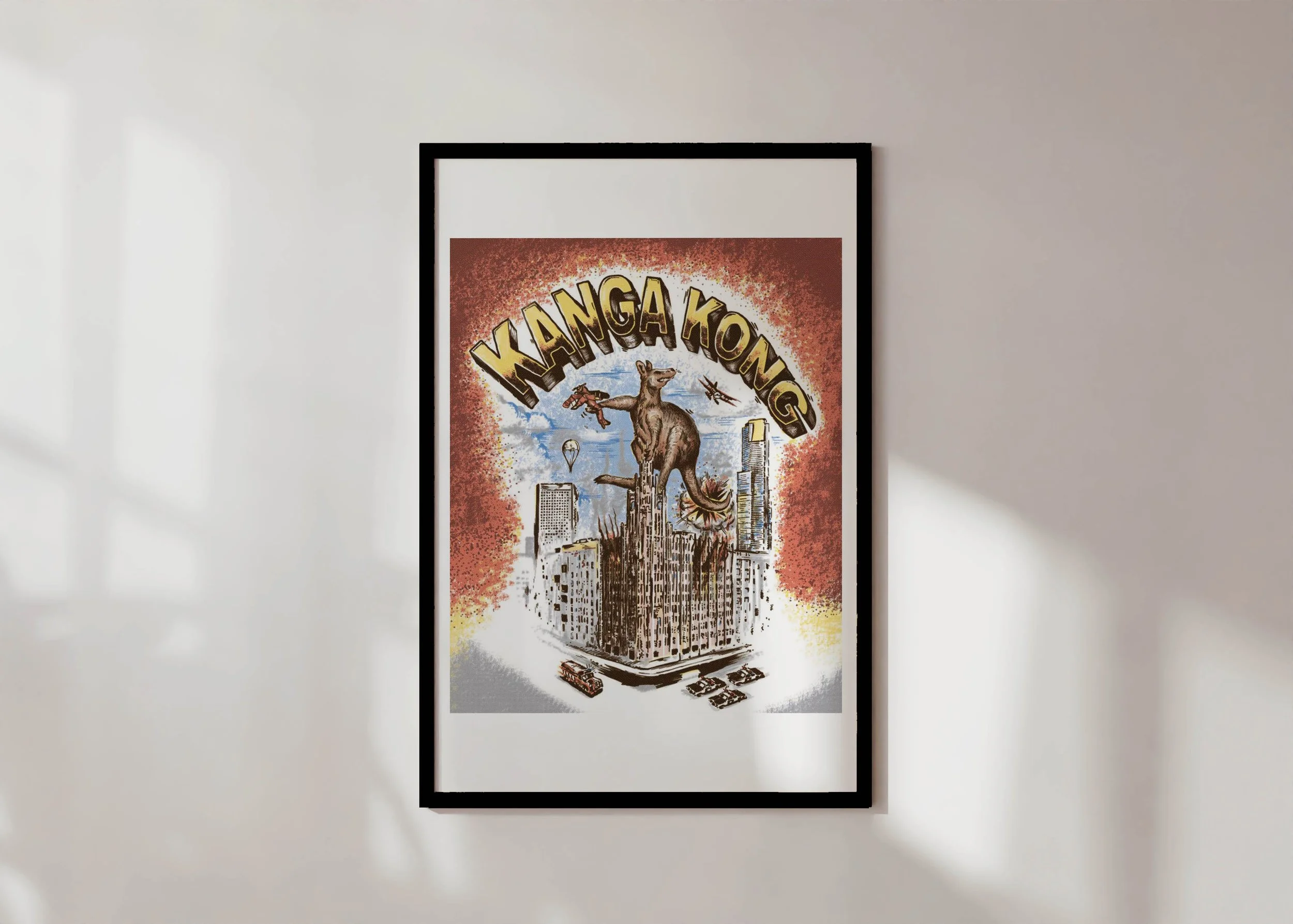 A framed Australiana colour print by ARMNP featuring a giant kangaroo atop a city building with planes circling.