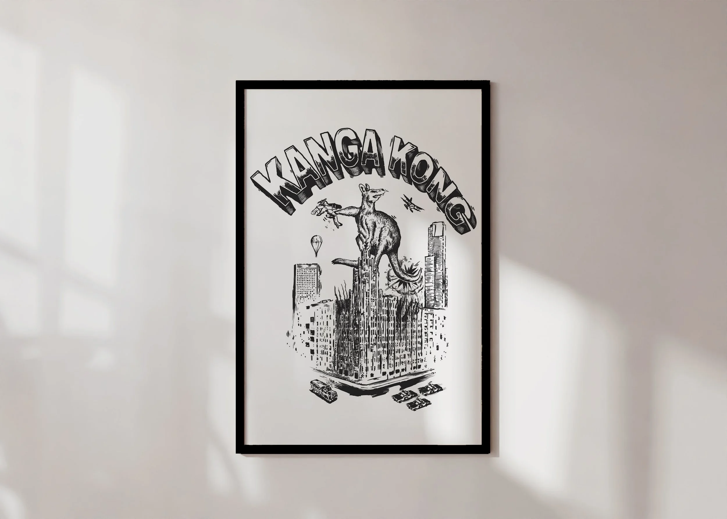 A framed Australiana print featuring a giant kangaroo atop a building with planes circling.