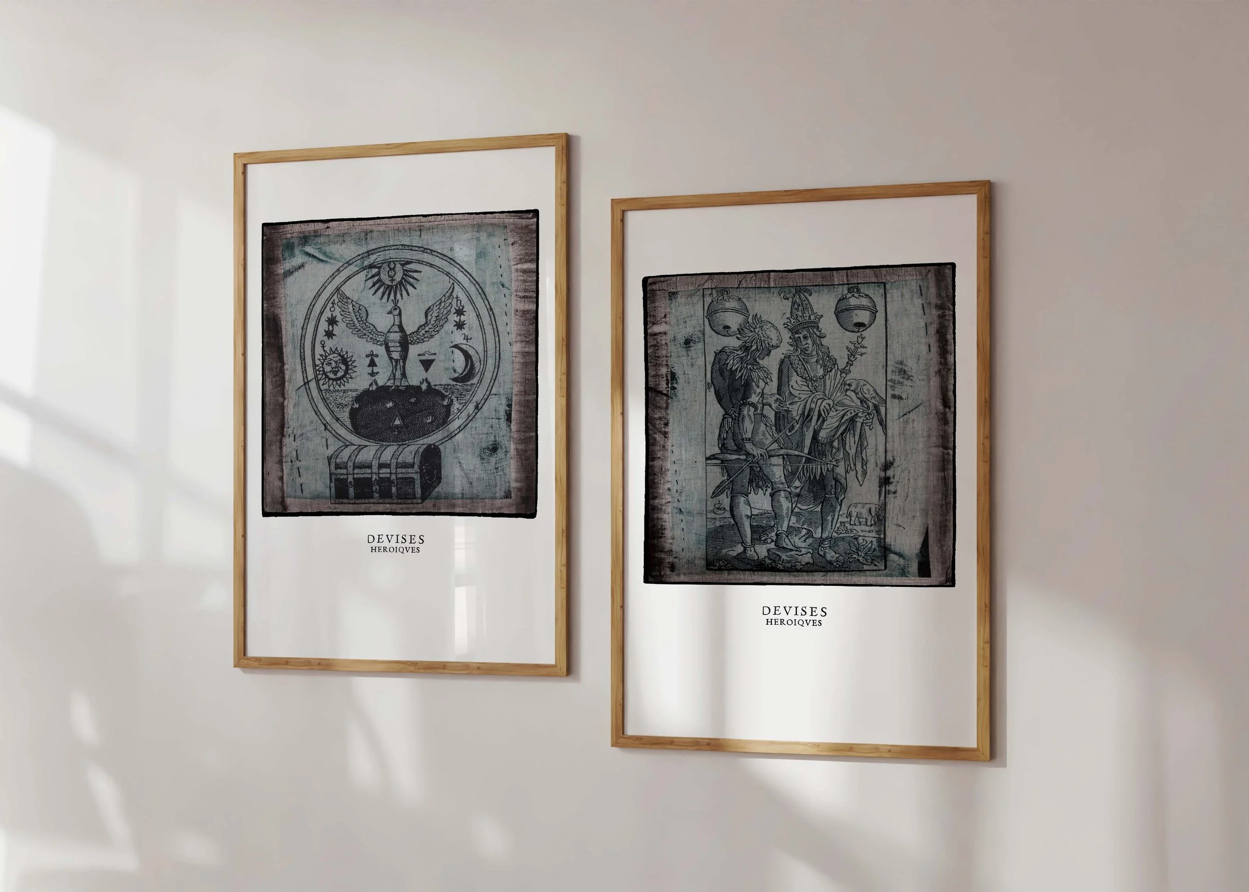Two framed decorex prints of illustrations by Claude Paradin with antique linen behind.
