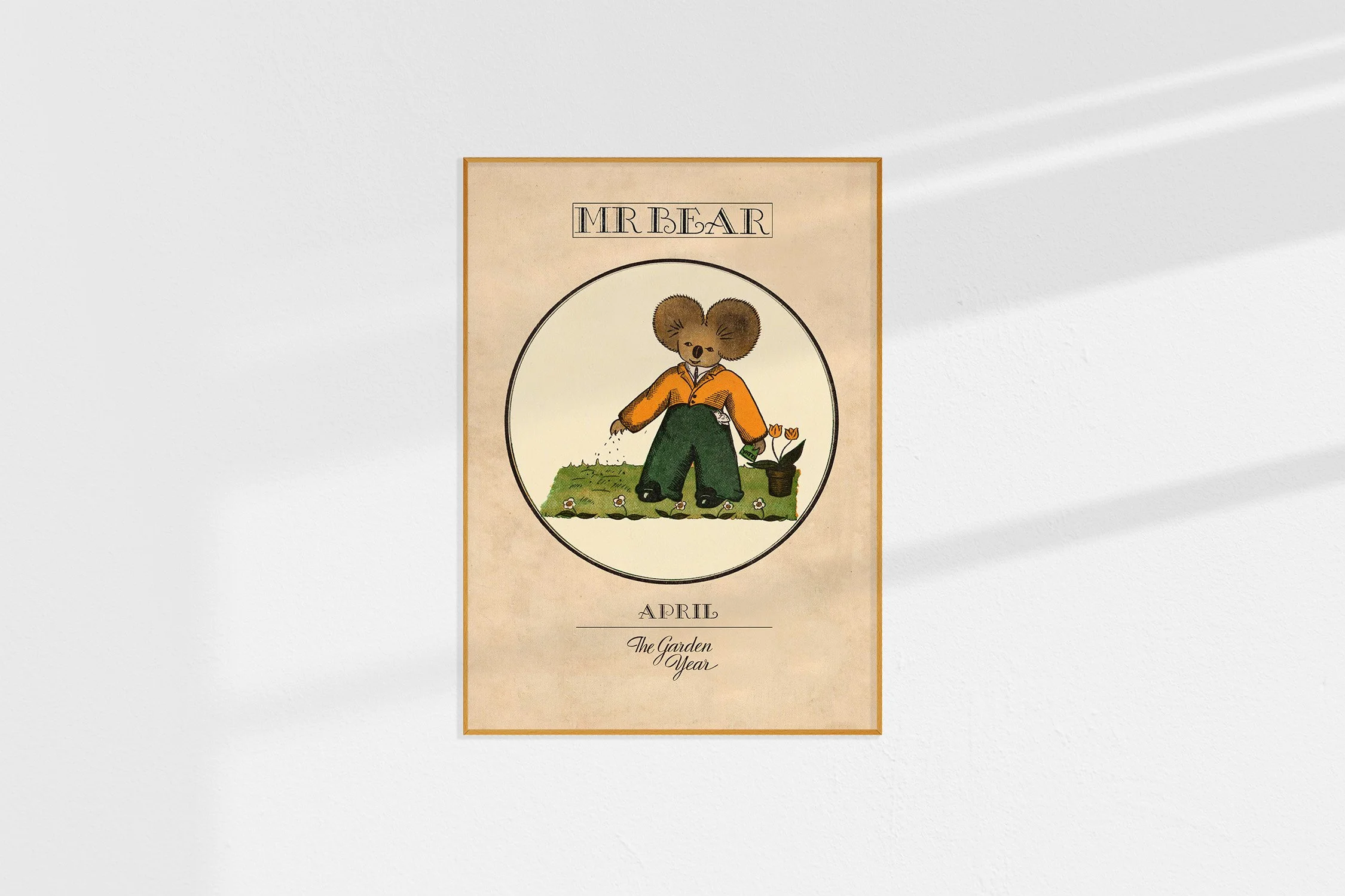 A framed Oz print with a koala Mr Bear in a roundel scattering seeds in April.