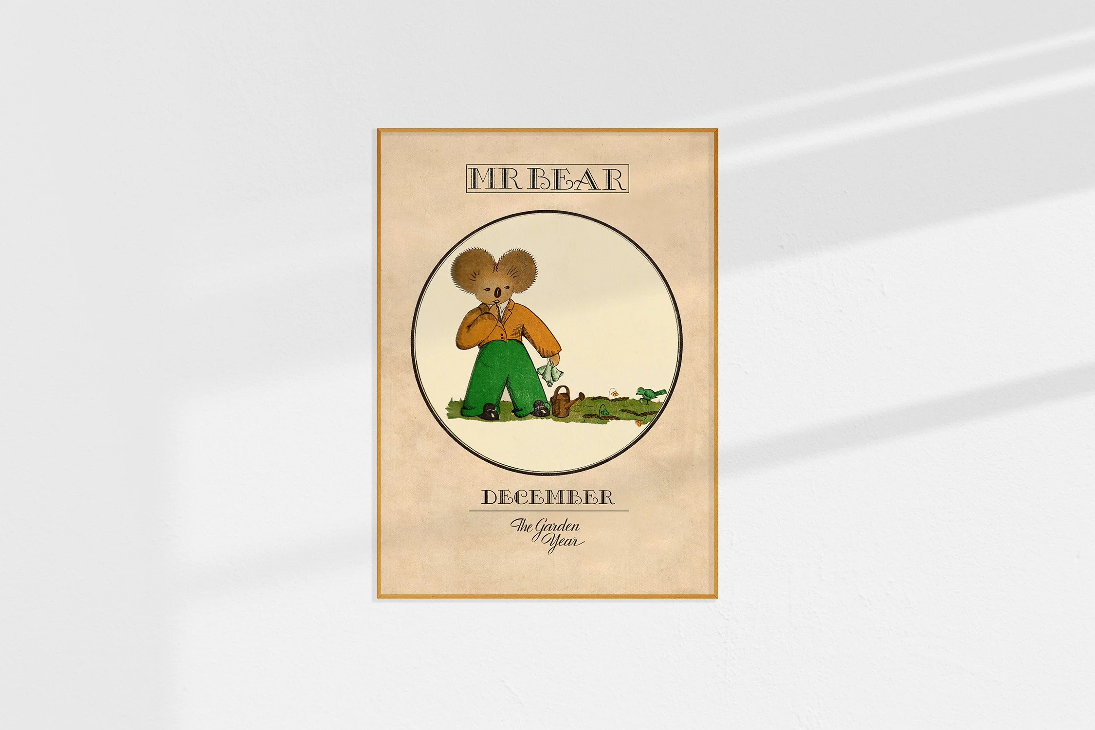 A framed Oz print with a koala Mr Bear with a hanky in a roundel.