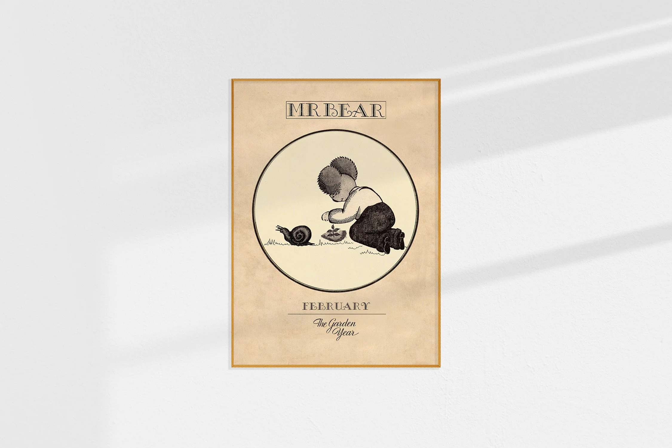 A framed Oz print of a koala Mr Bear in a roundel planting a seed with a snail beside him.