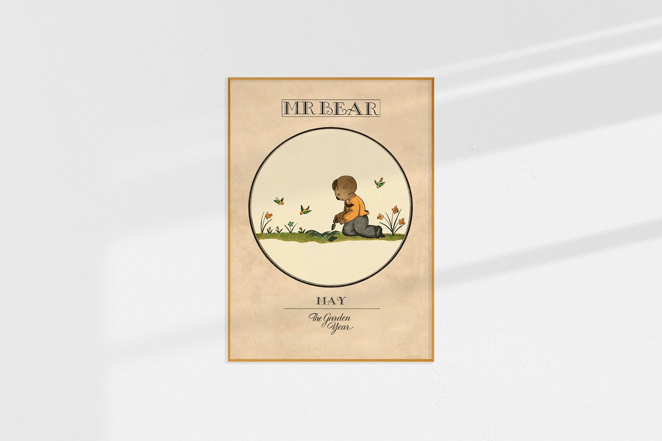 A framed Oz print with a koala Mr Bear in a roundel kneeling amongst the daffodils and with birds in the sky.