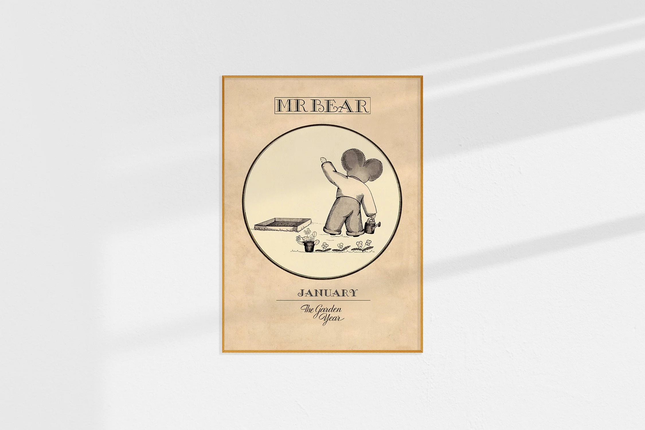 A framed Oz print of a back view of a koala Mr Bear in a roundel with him watering seedlings.