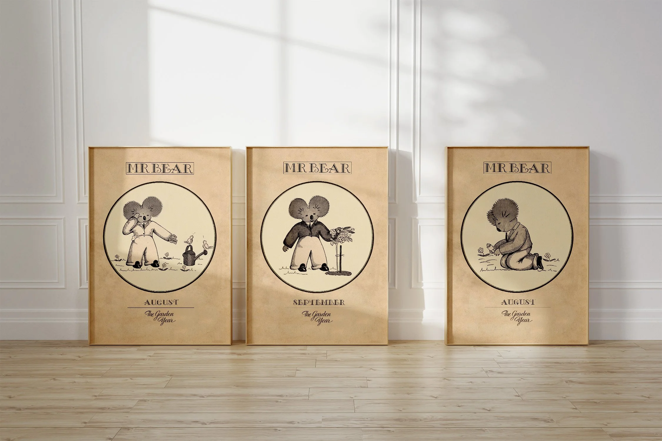 Three framed Oz prints of a koala Mr Bear, with birds singing and planting seeds in August and with roses in September.