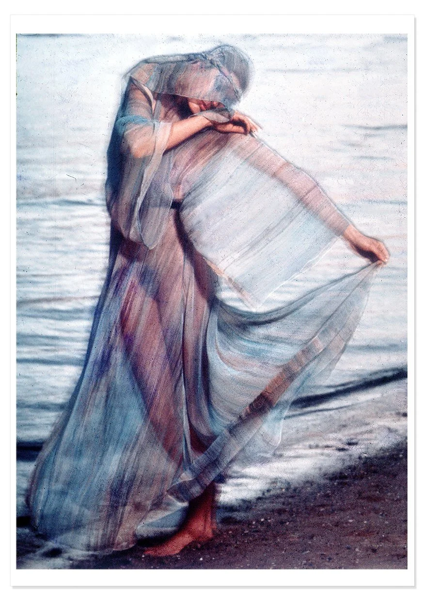 Photographic image by Colin Beard of a girl in a floaty see-through dress on the beach in an astrology shoot for the Cancer star sign and with drop shadow.