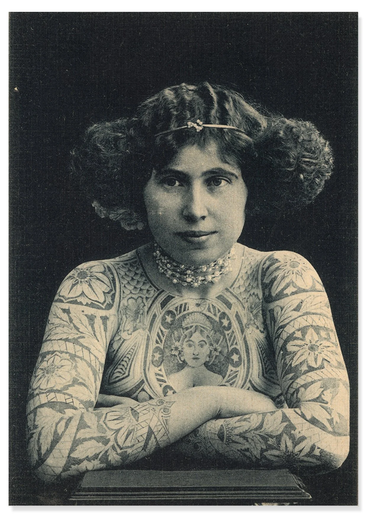 Head and shoulders vintage image of a tattoed lady in the early 1900s with drop shadow.