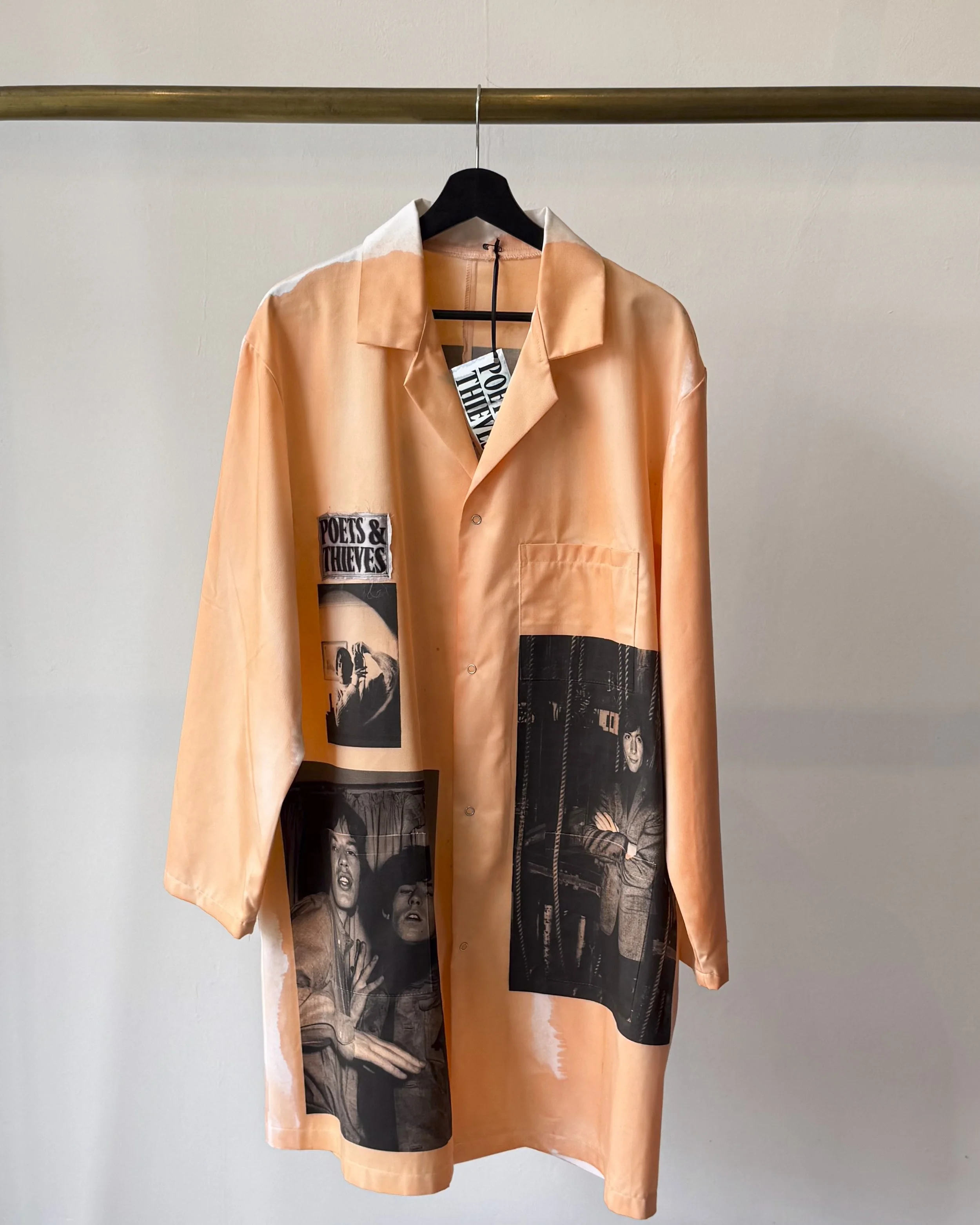 Front view of lab coat with artistic treatment in orange and featuring image of the Rolling Stones and Colin Beard.