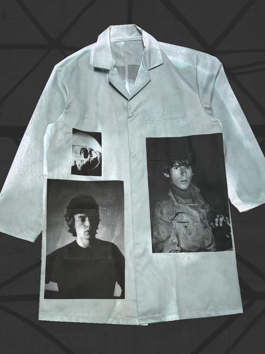 Front view of a designer lab coat featuring grey/green distressed oxidisation and photographic images by Colin Beard of Mick Jagger and Keith Richards of the Rolling Stones.