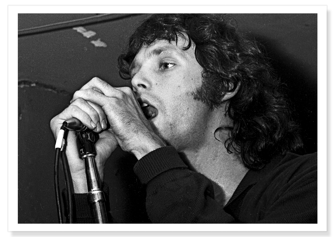 Black and white close-up head photographic portrait of Jim Morrison performing in New York. Print shows borders and drop shadow.