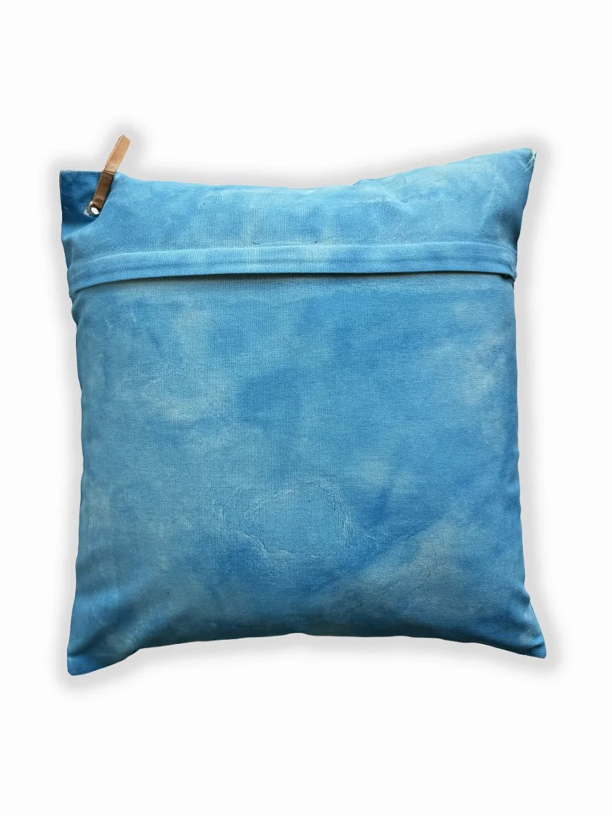 Back view of a cushion with an artistic washed background in sky blue.