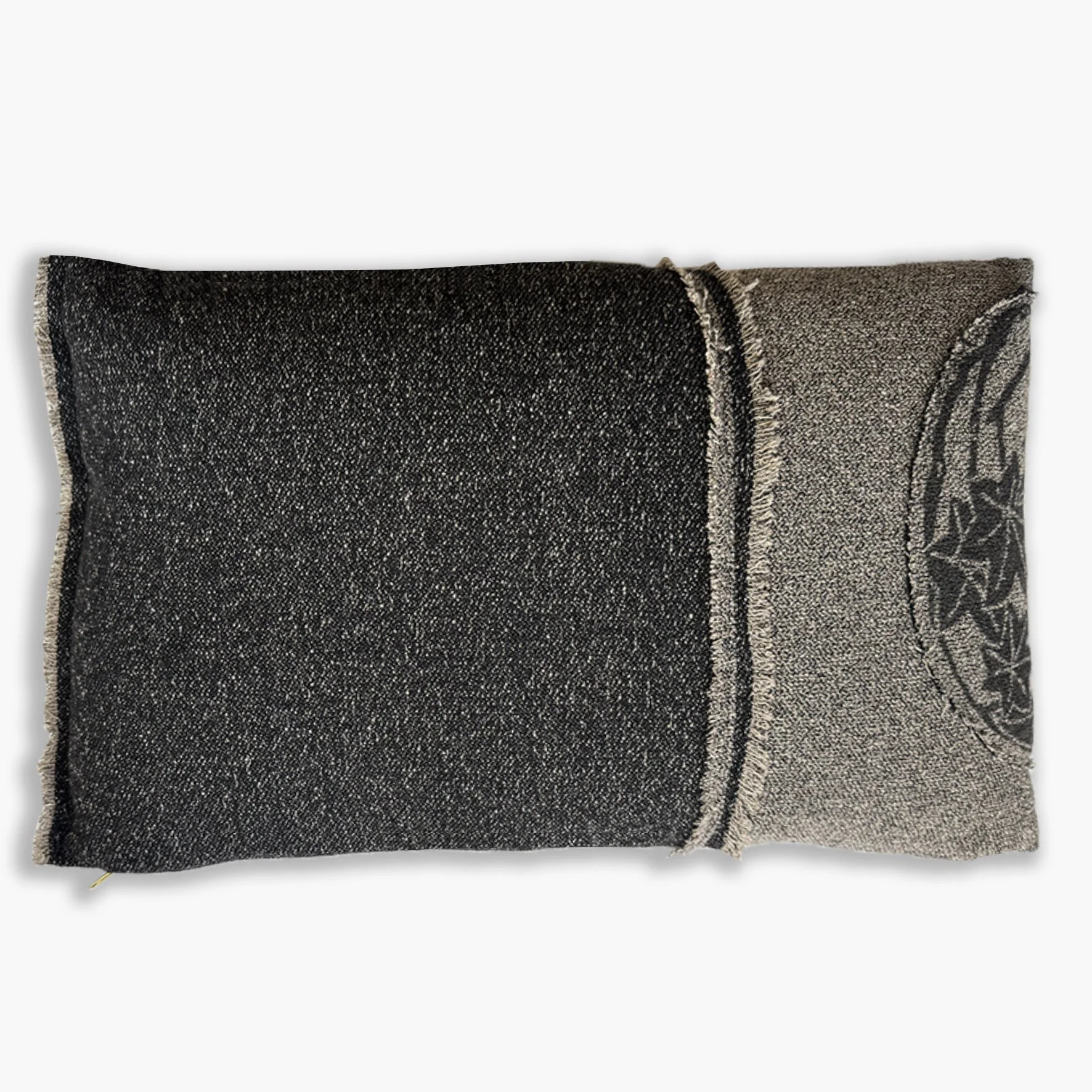 Back view of two tone monochromatic wool and silk cushion with feature frayed edge and a silk botanic patch in black and cream.
