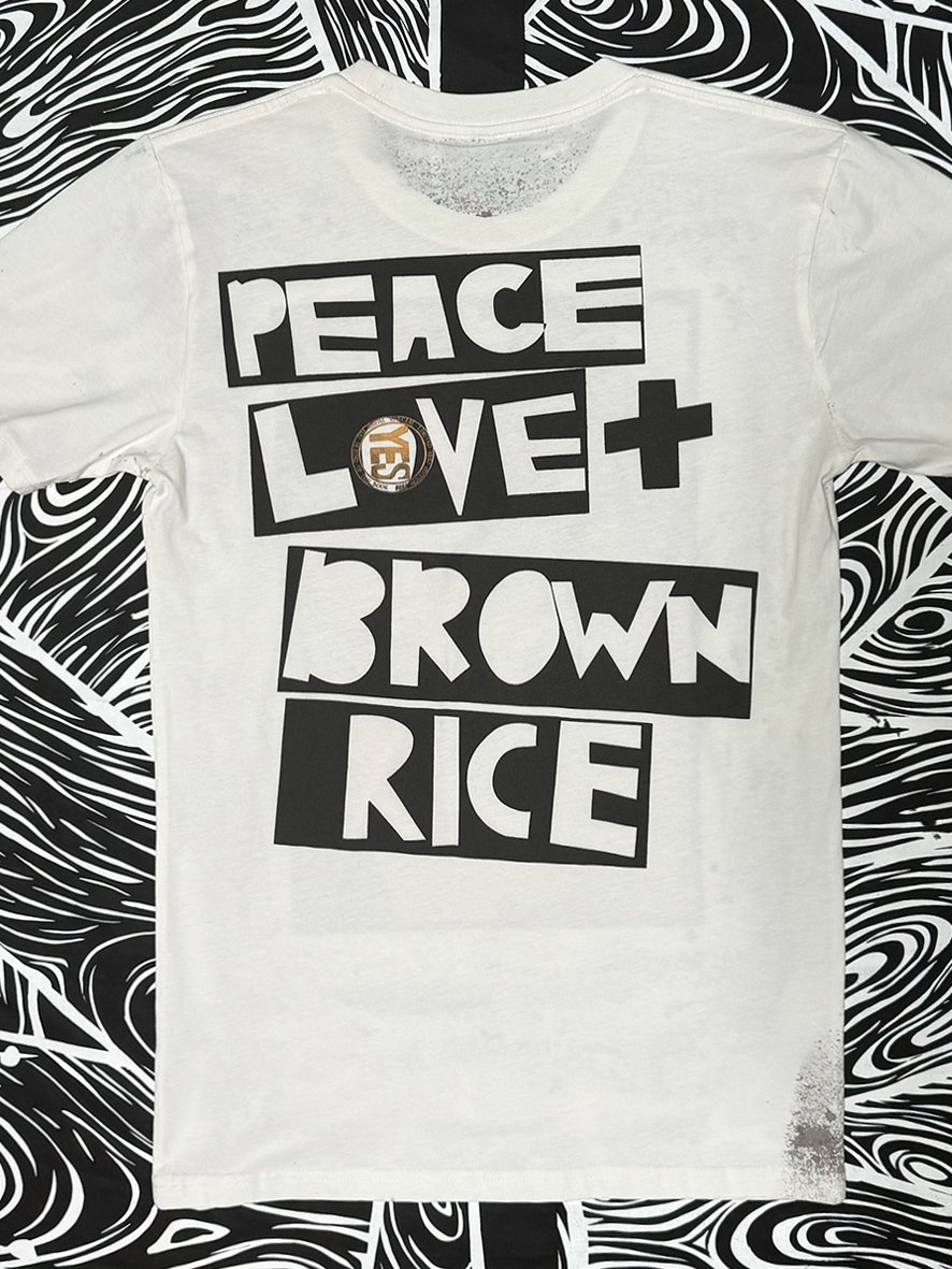 Back view of natural tee with a large Peace Love and Brown Rice logo print.