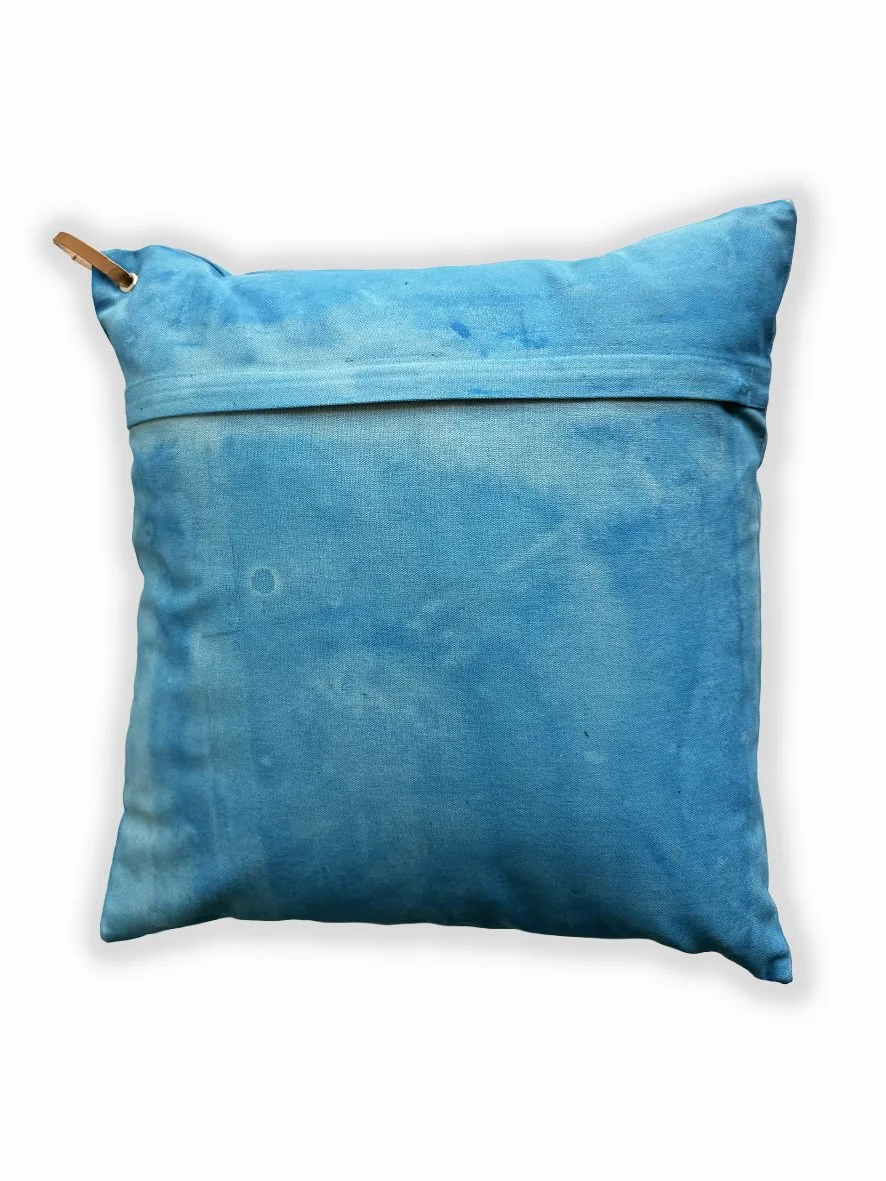 Back view of a cushion with an artistic washed background in sky blue.