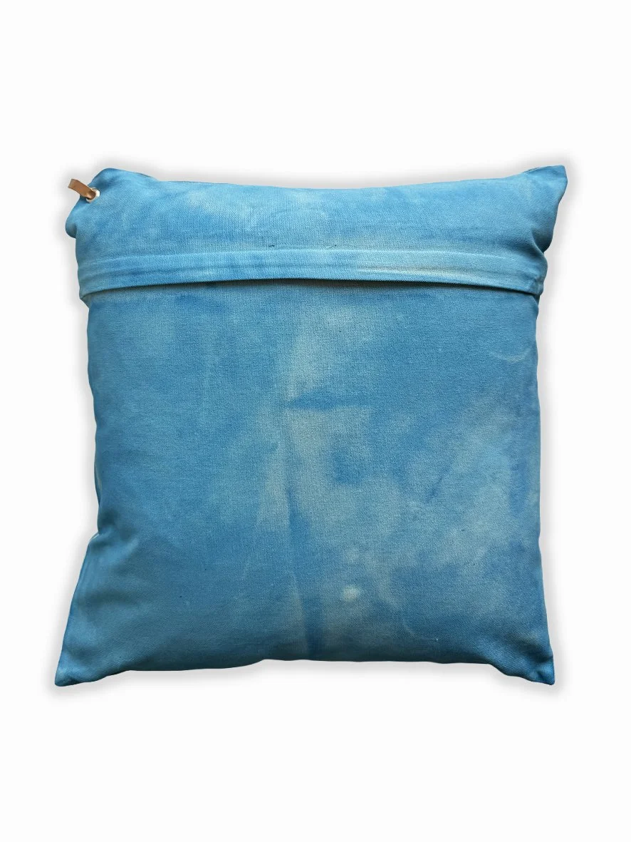 Back view of a cushion with an artistic washed background in sky blue.