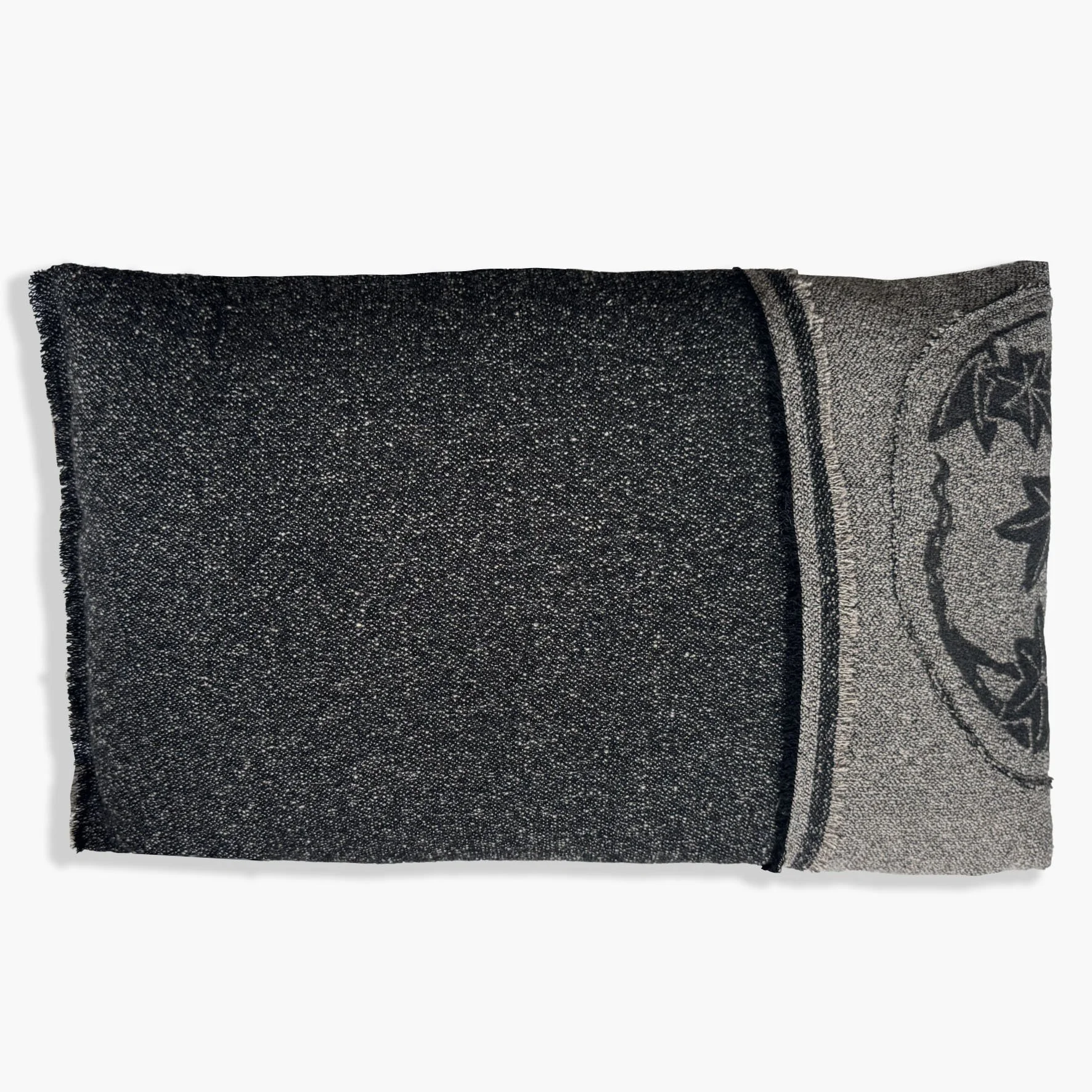 Back view of two tone monochromatic wool and silk cushion with feature frayed edge and a silk botanic patch in black and cream.