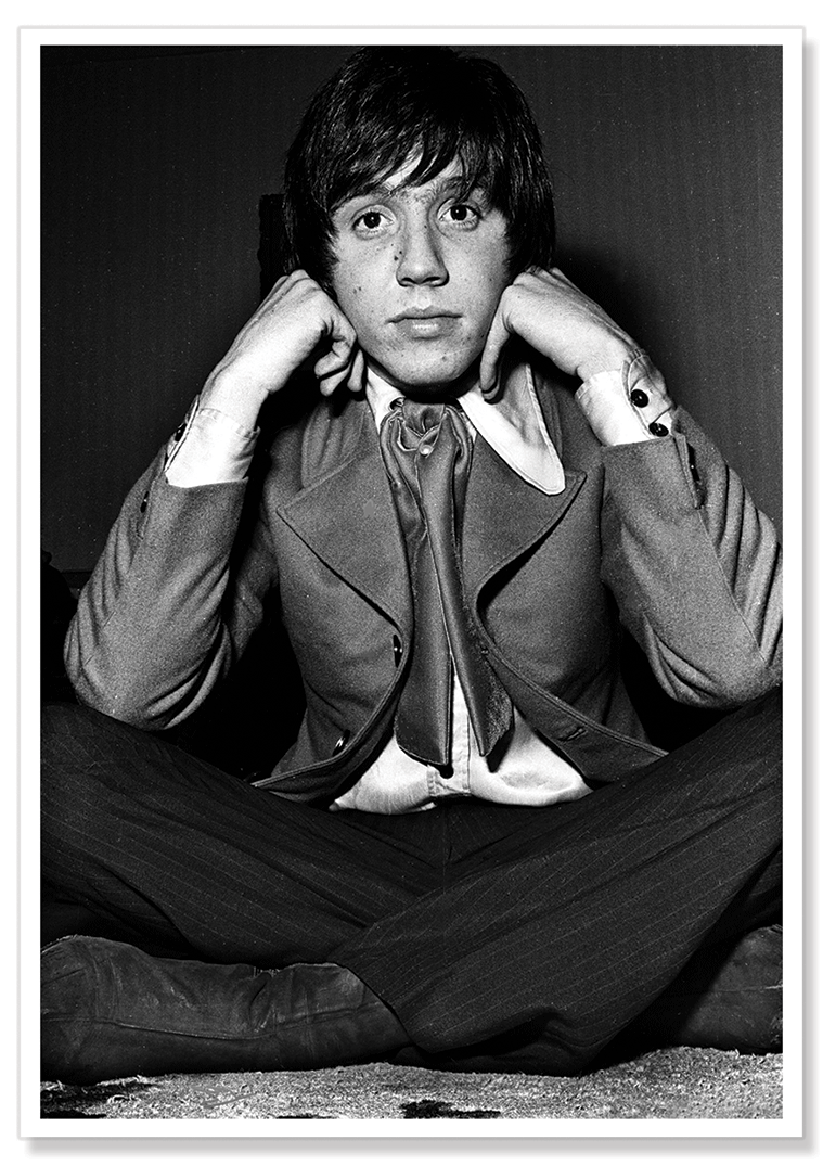 Black and white portrait shot of Stevie Wright from the Easybeats resting on his hands and looking directly at the camera.  Print shows borders and drop shadow.