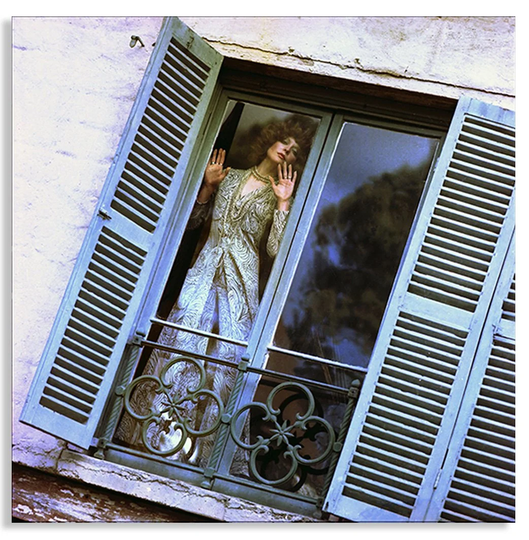 Photographic image by Colin Beard of a girl at a Juliet balcony window in an astrology shoot for the Virgo star sign with a drop shadow..